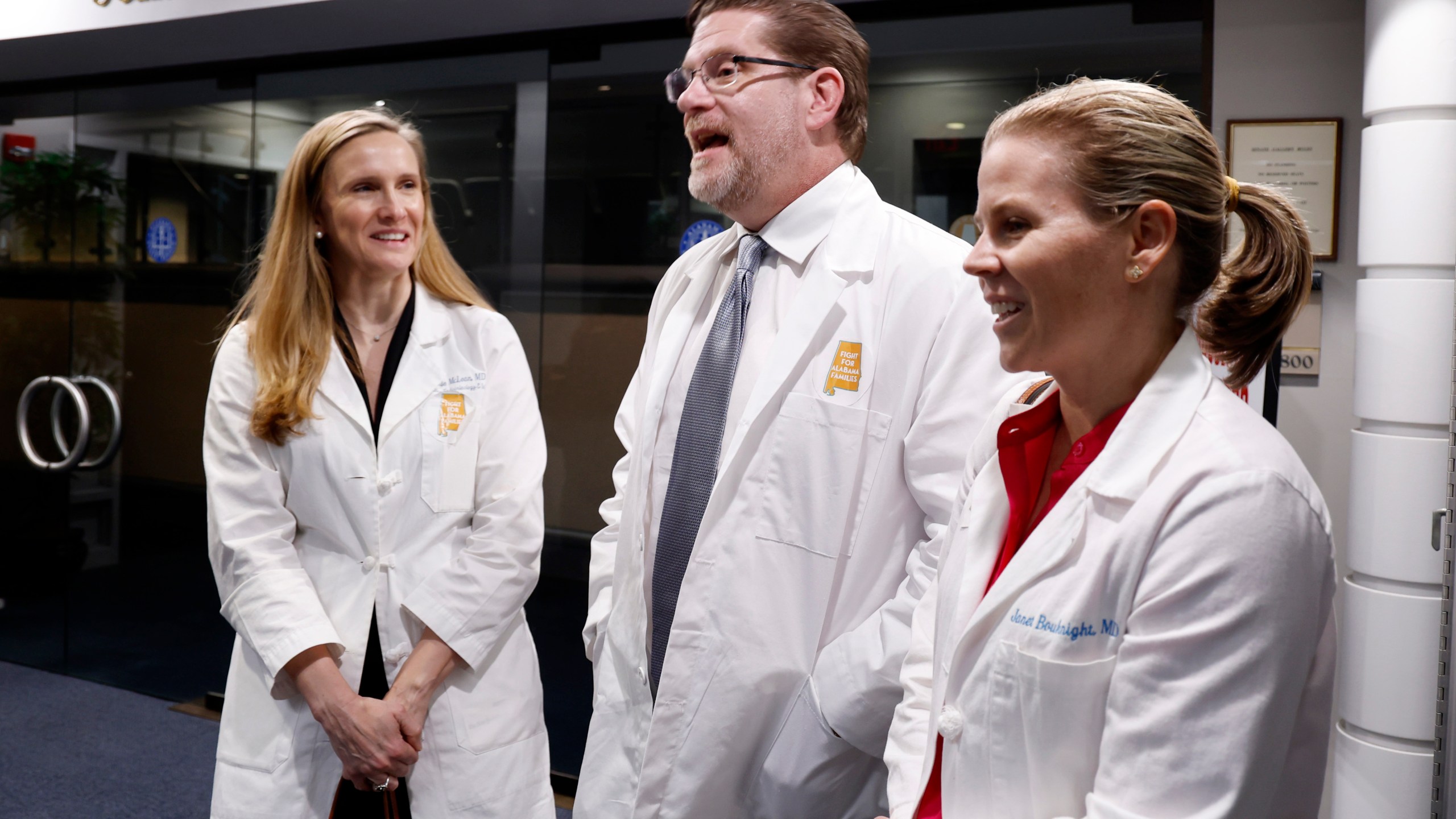 Dr. Mamie McLean, left, Dr. Michael Allemand, center, and Dr. Janet Bouknight, right, react after the Senate passed SB159 bill (IVF Fertility Bill), Wednesday, March 6, 2024, in Montgomery, Ala. (AP Photo/ Butch Dill)