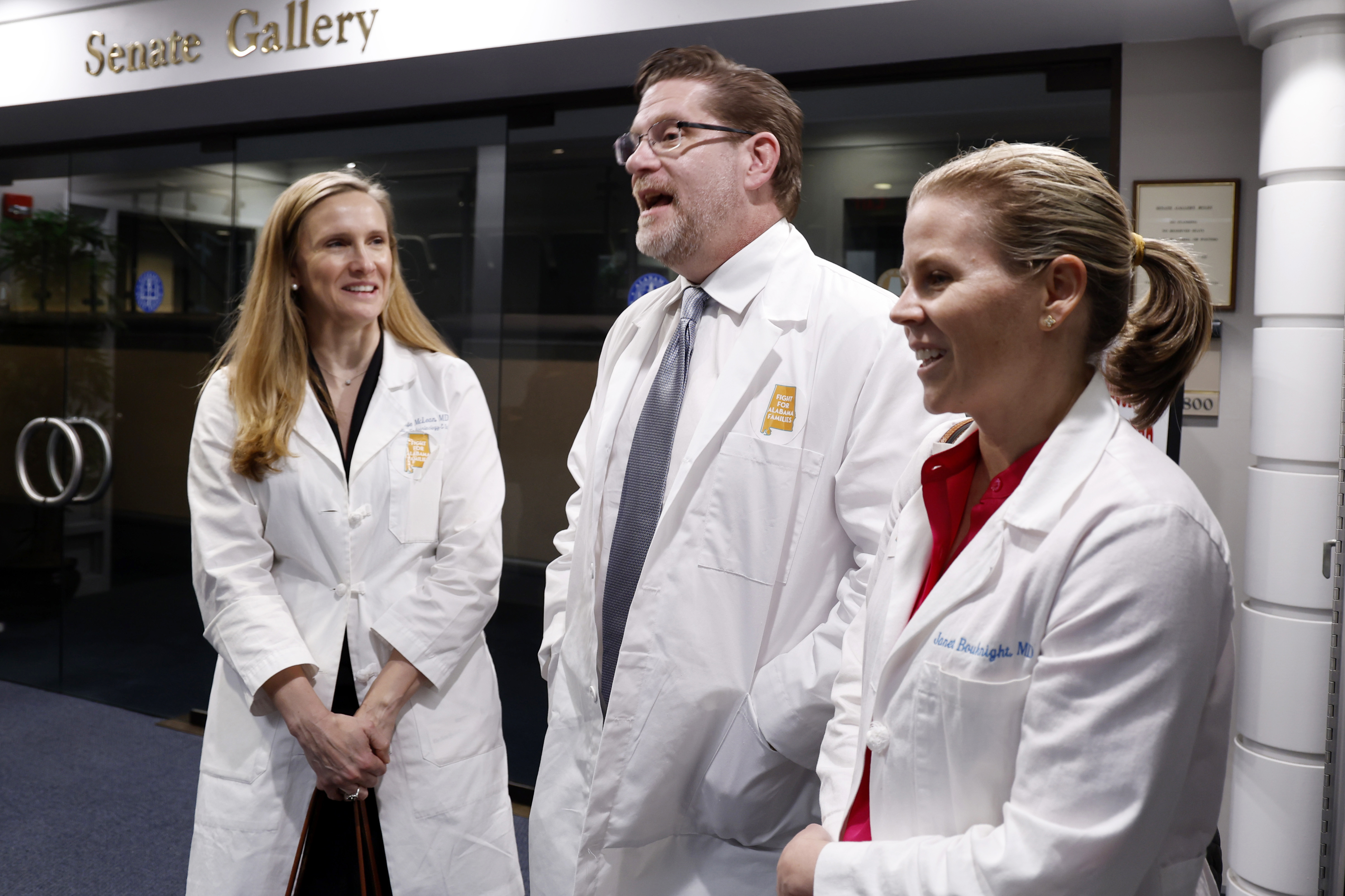 Dr. Mamie McLean, left, Dr. Michael Allemand, center, and Dr. Janet Bouknight, right, react after the Senate passed SB159 bill (IVF Fertility Bill), Wednesday, March 6, 2024, in Montgomery, Ala. (AP Photo/ Butch Dill)