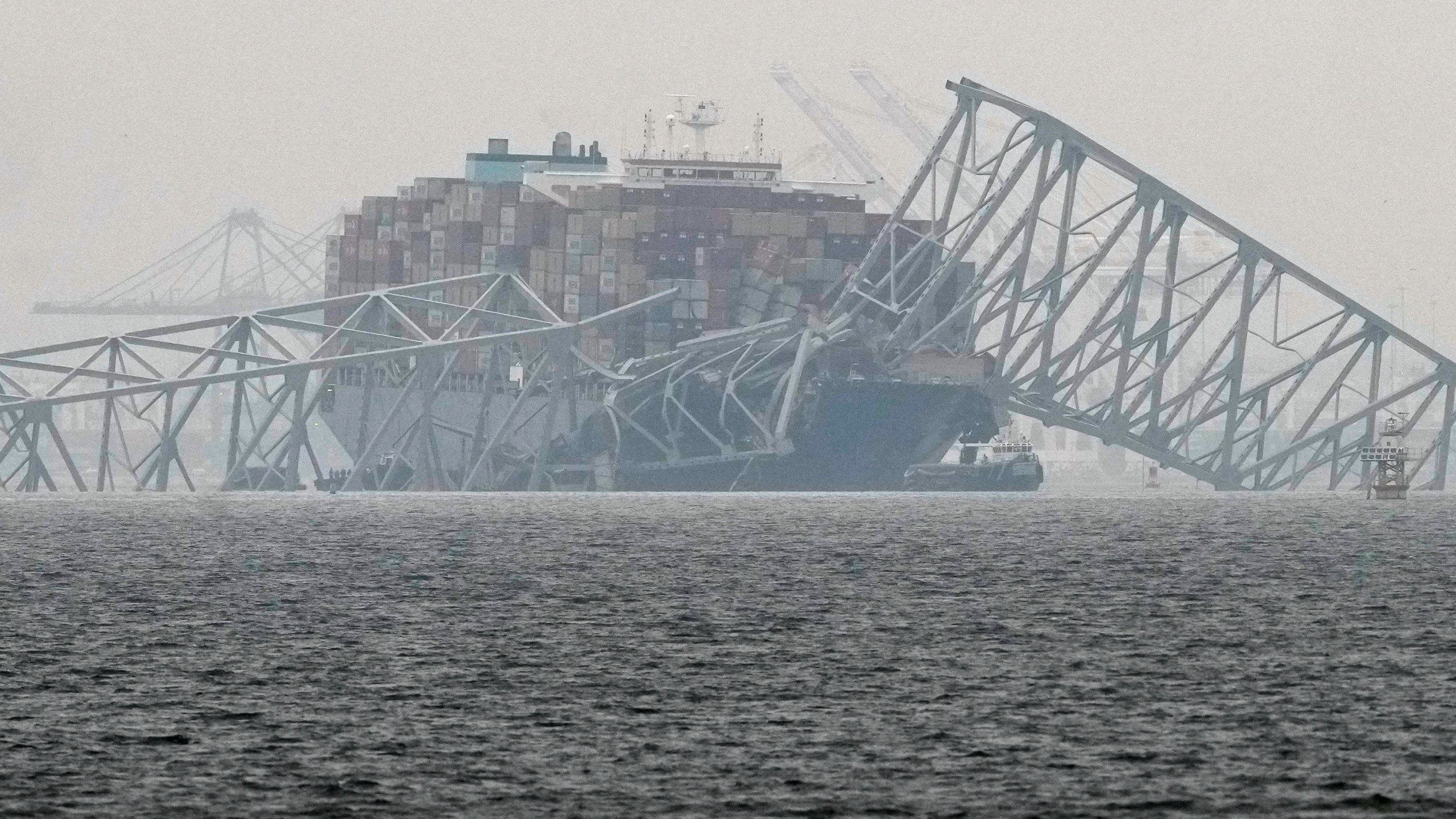 A container ship rests against the wreckage of the Francis Scott Key Bridge on Thursday, March 28, 2024, in Baltimore, Md. After days of searching through murky water for the workers missing after the bridge collapsed, officials are turning their attention Thursday to what promises to be a massive salvage operation. (AP Photo/Matt Rourke)