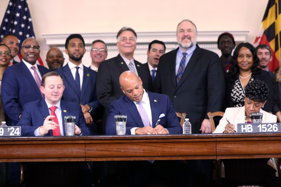 Maryland Gov. Wes Moore signs legislation on Tuesday, April 9, 2024 in Annapolis, Md., to help employees of the Port of Baltimore affected by the Francis Scott Key Bridge collapse. It authorizes use of the state's rainy day fund to provide financial help. (AP Photo/Brian Witte)