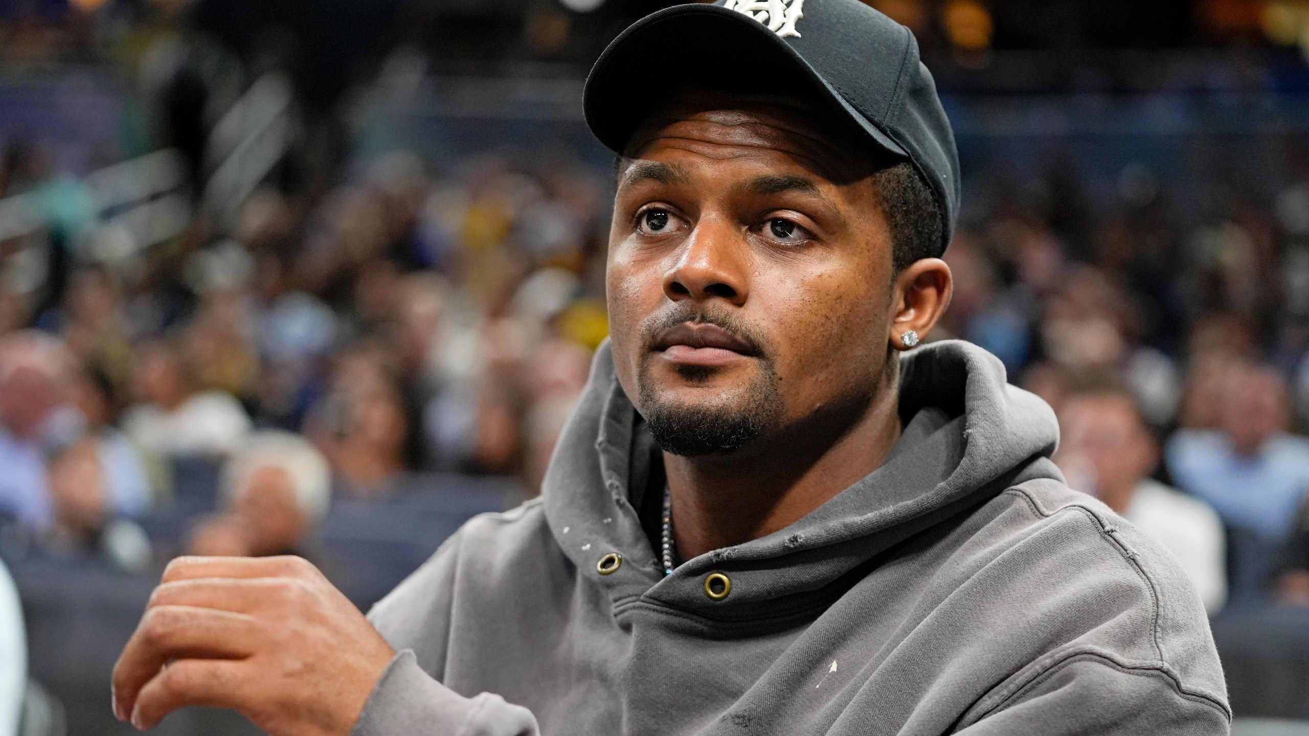 Cleveland Browns quarterback Deshaun Watson watches during the second half of an NBA basketball game between the Orlando Magic and the Golden State Warriors, Wednesday, March 27, 2024, in Orlando, Fla. (AP Photo/John Raoux)