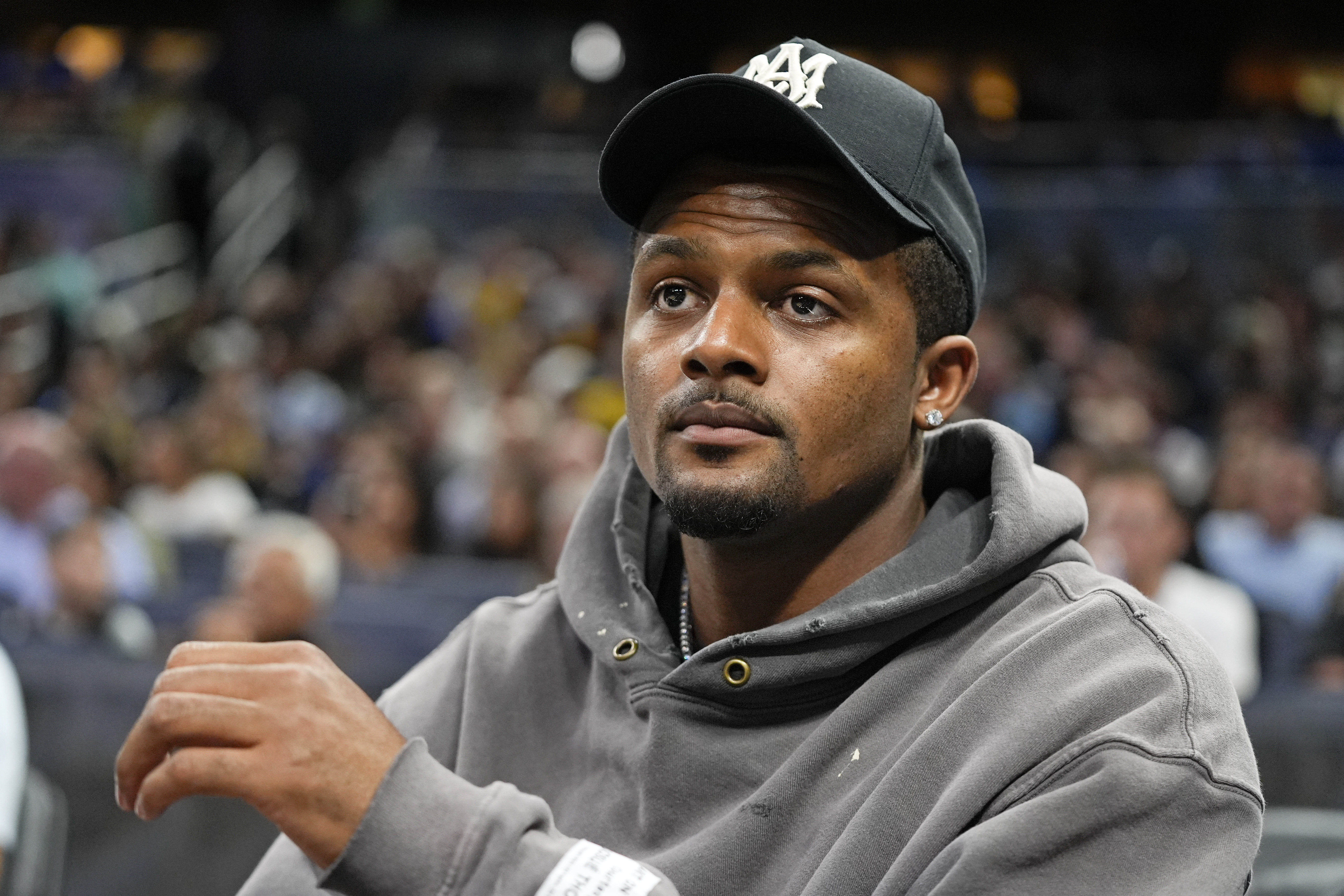 Cleveland Browns quarterback Deshaun Watson watches during the second half of an NBA basketball game between the Orlando Magic and the Golden State Warriors, Wednesday, March 27, 2024, in Orlando, Fla. (AP Photo/John Raoux)