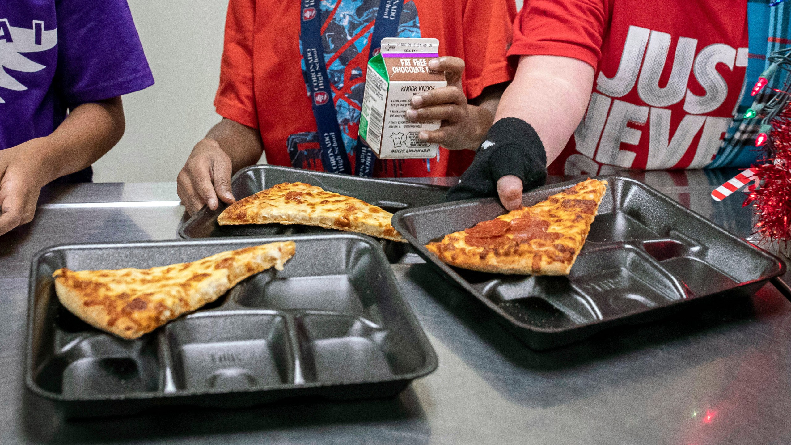 FILE - Second-grade students select their meals during their lunch break in the cafeteria, Dec. 12, 2022, at an elementary school in Scottsdale, Ariz. The nation's school meals will get a makeover under new nutrition standards that limit added sugars for the first time, the U.S. Department of Agriculture announced Wednesday, April 24, 2024. (AP Photo/Alberto Mariani, File)