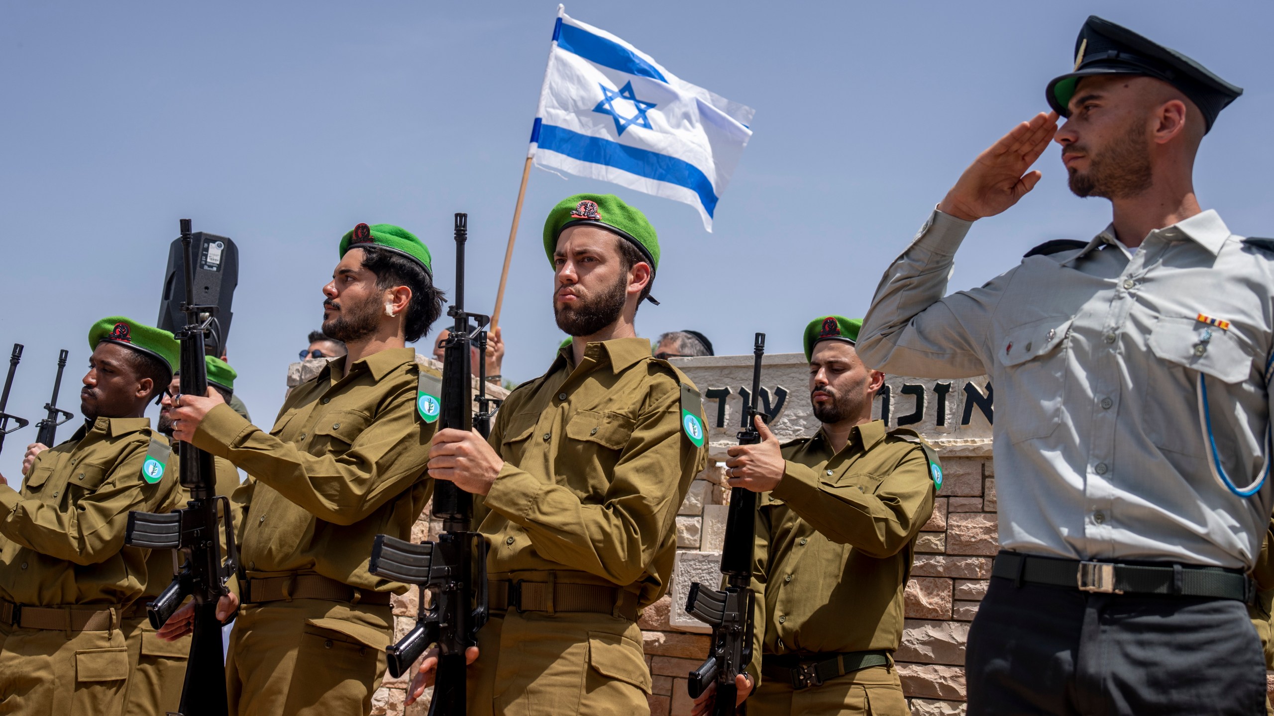 Israeli honor guard soldiers salute during the funeral Israeli reserve Major Dor Zimel in Even Yehuda, Israel, Monday, April 22, 2024. Zimel , 27, died of his wounds after Iran-backed Lebanese militant Hezbollah group fired a volley of rockets and drones on northern Israel on April 17. The attack wounded at least 14 Israeli soldiers, six seriously, the army said. (AP Photo/Ariel Schalit)