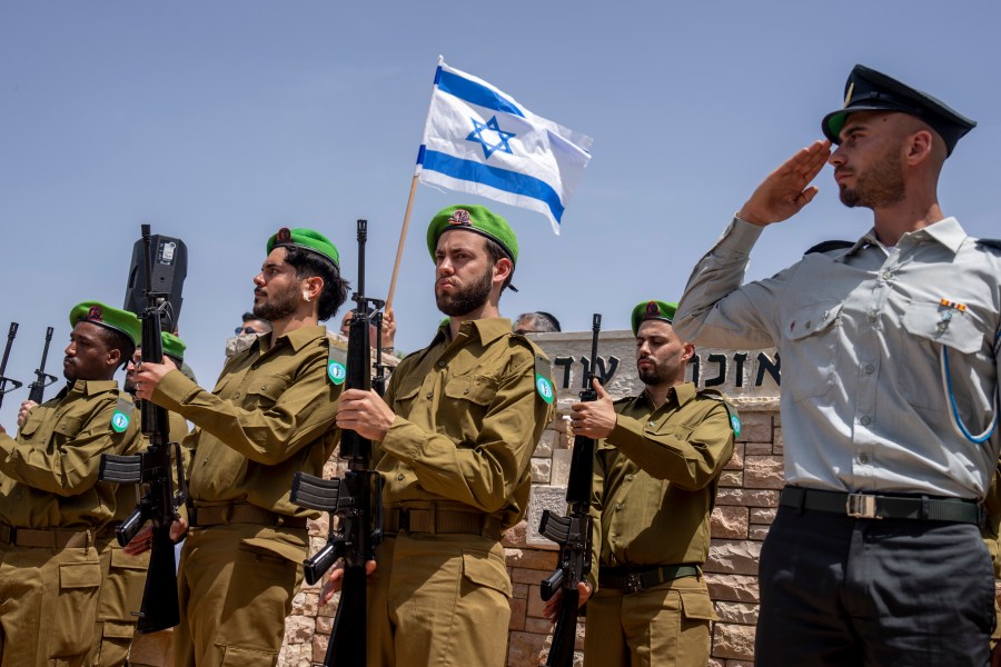 Israeli honor guard soldiers salute during the funeral Israeli reserve Major Dor Zimel in Even Yehuda, Israel, Monday, April 22, 2024. Zimel , 27, died of his wounds after Iran-backed Lebanese militant Hezbollah group fired a volley of rockets and drones on northern Israel on April 17. The attack wounded at least 14 Israeli soldiers, six seriously, the army said. (AP Photo/Ariel Schalit)