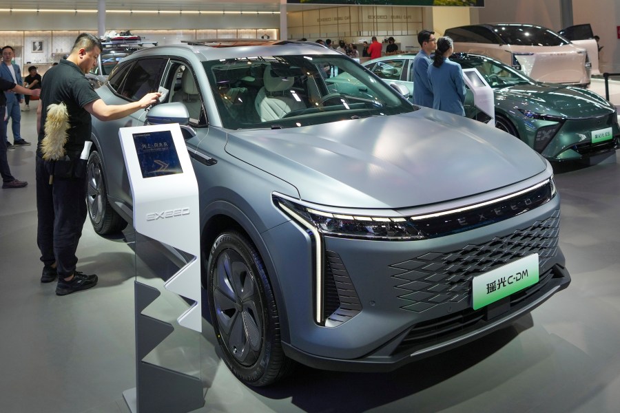 A worker cleans an Exeed C-DM car during the China Auto Show in Beijing, China, Friday, April 26, 2024. China's vision of the future of the automobile — electrified and digitally connected — is on display at the ongoing Beijing auto show. (AP Photo/Tatan Syuflana)