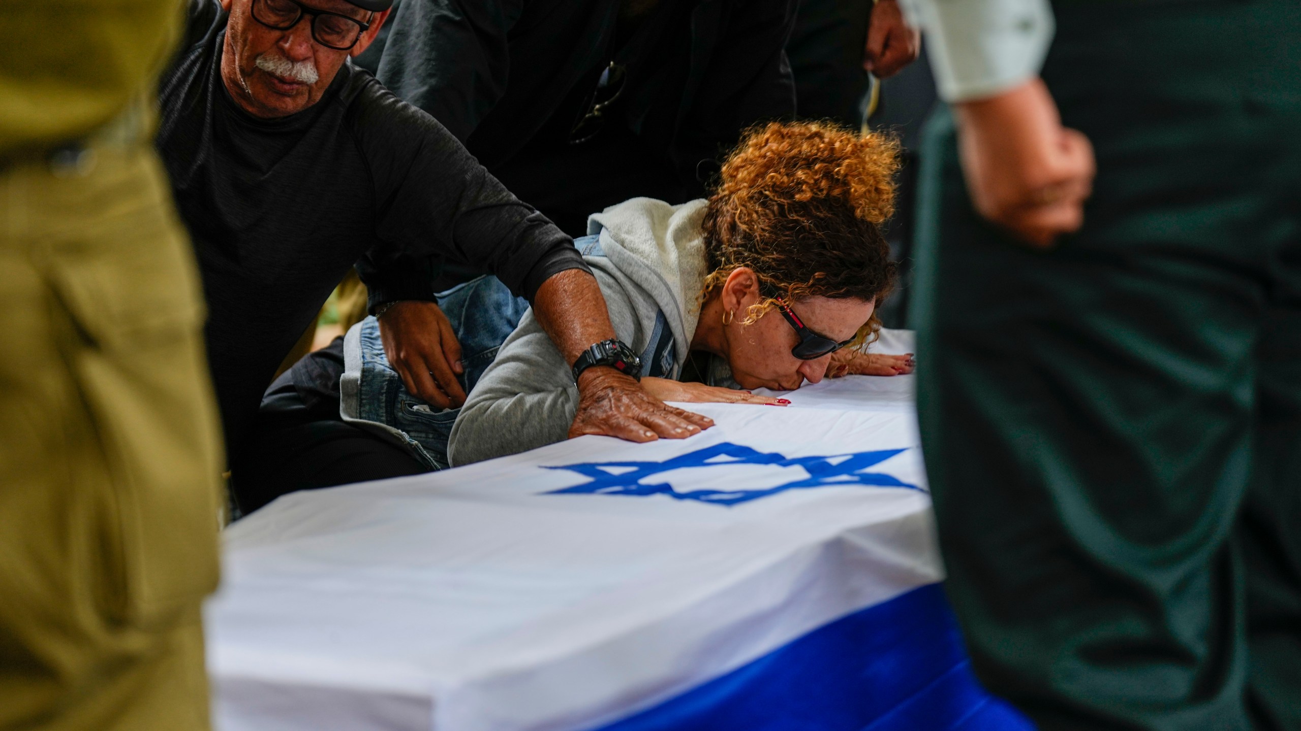 Ami Aviv mother of Israeli reserve soldier Master sergeant Ido Aviv kisses his casket during his the funeral in Carmiel, northern Israel, Tuesday, April 30, 2024. Aviv, 28, was killed during Israel's ground operation in the Gaza Strip, where the Israeli army has been battling Palestinian militants in the war ignited by Hamas' Oct. 7 attack into Israel. (AP Photo/Ariel Schalit)