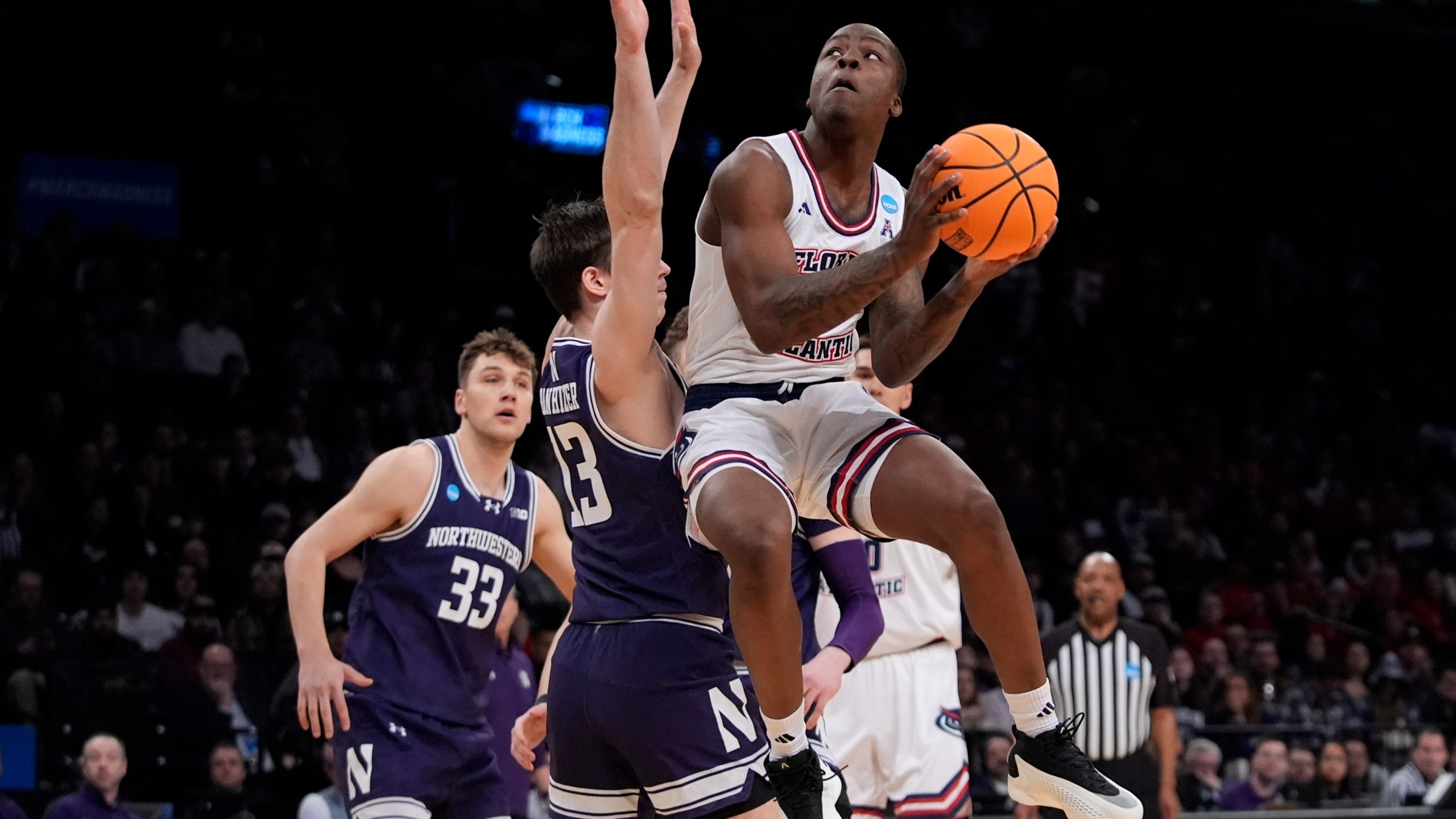 FILE - Florida Atlantic's Johnell Davis (1) drives past Northwestern's Brooks Barnhizer (13) during the first half of a first-round college basketball game in the NCAA Tournament, Friday, March 22, 2024, in New York. Davis has committed to play for John Calipari at Arkansas. (AP Photo/Frank Franklin II, File)