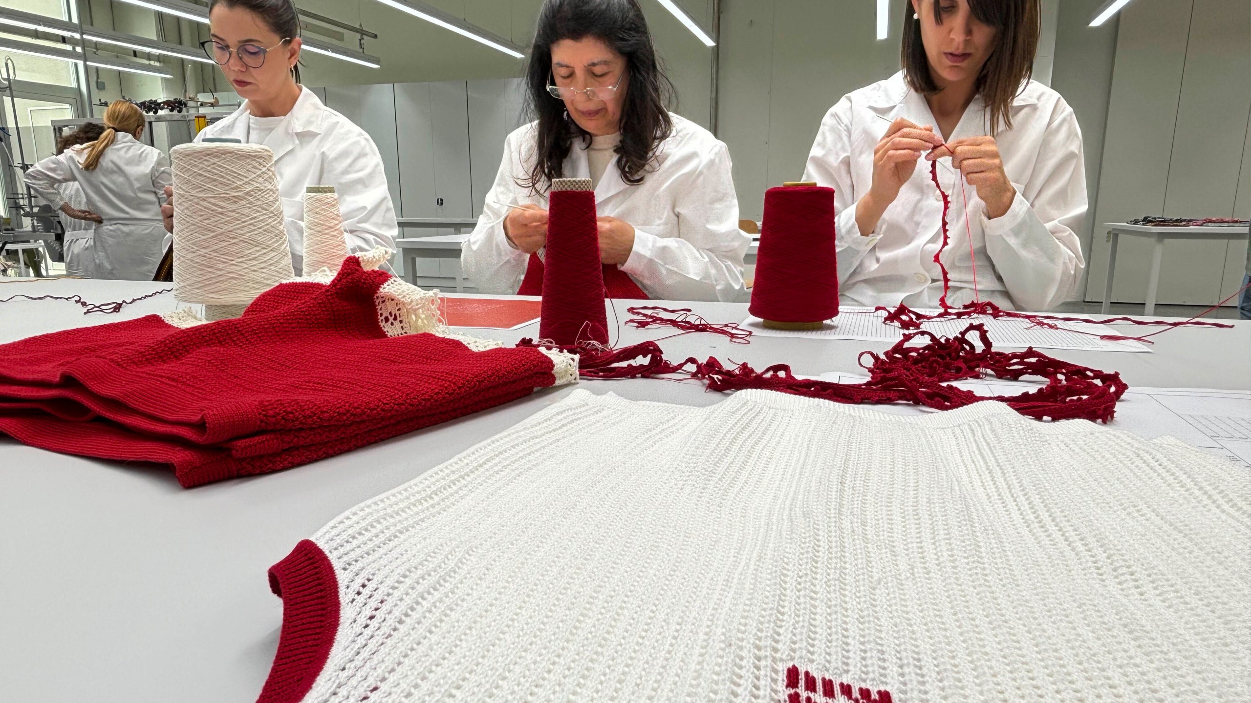 Italian artesans create knitwear for the Prada and Miu Miu brands at a recently expanded factory in the Perugia province of Italy Tuesday, May 7, 2024. The Prada Group is expanding its production footprint in Italy, including dozens of new jobs at brand's knitwear factory near Umbria, leaning into Made in Italy as integral to the brand's ethos as it develops new artisanal talent to ease the luxury group through a generational shift in its workforce, alongside the management and creative transitions already under way. (AP Photo/Colleen Barry)