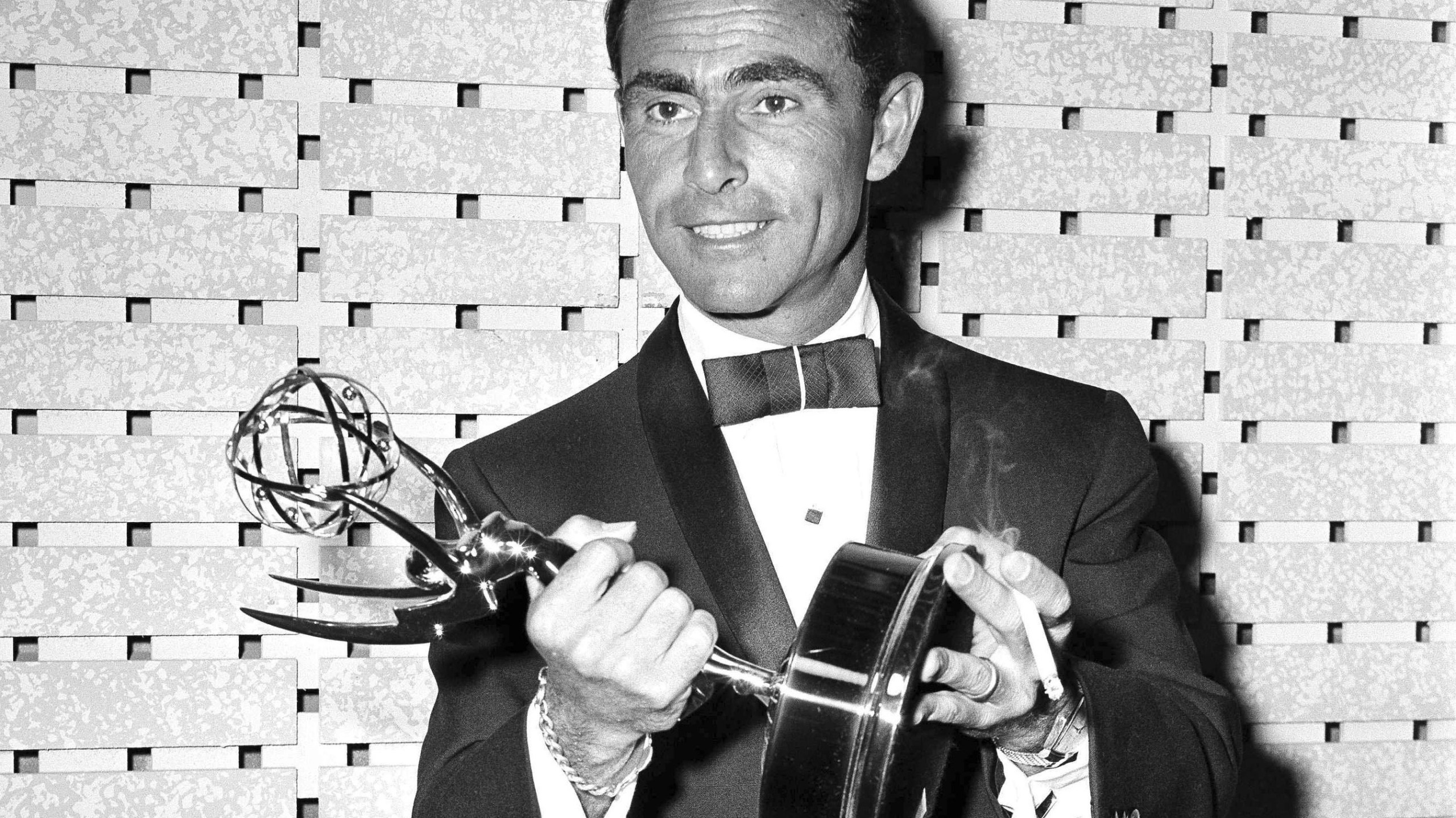 FILE - Writer Rod Serling holds the Emmy for best writing of a drama series for his work on "The Twilight Zone," at the Emmy Awards in Los Angeles on May 16, 1961. (AP Photo, File)