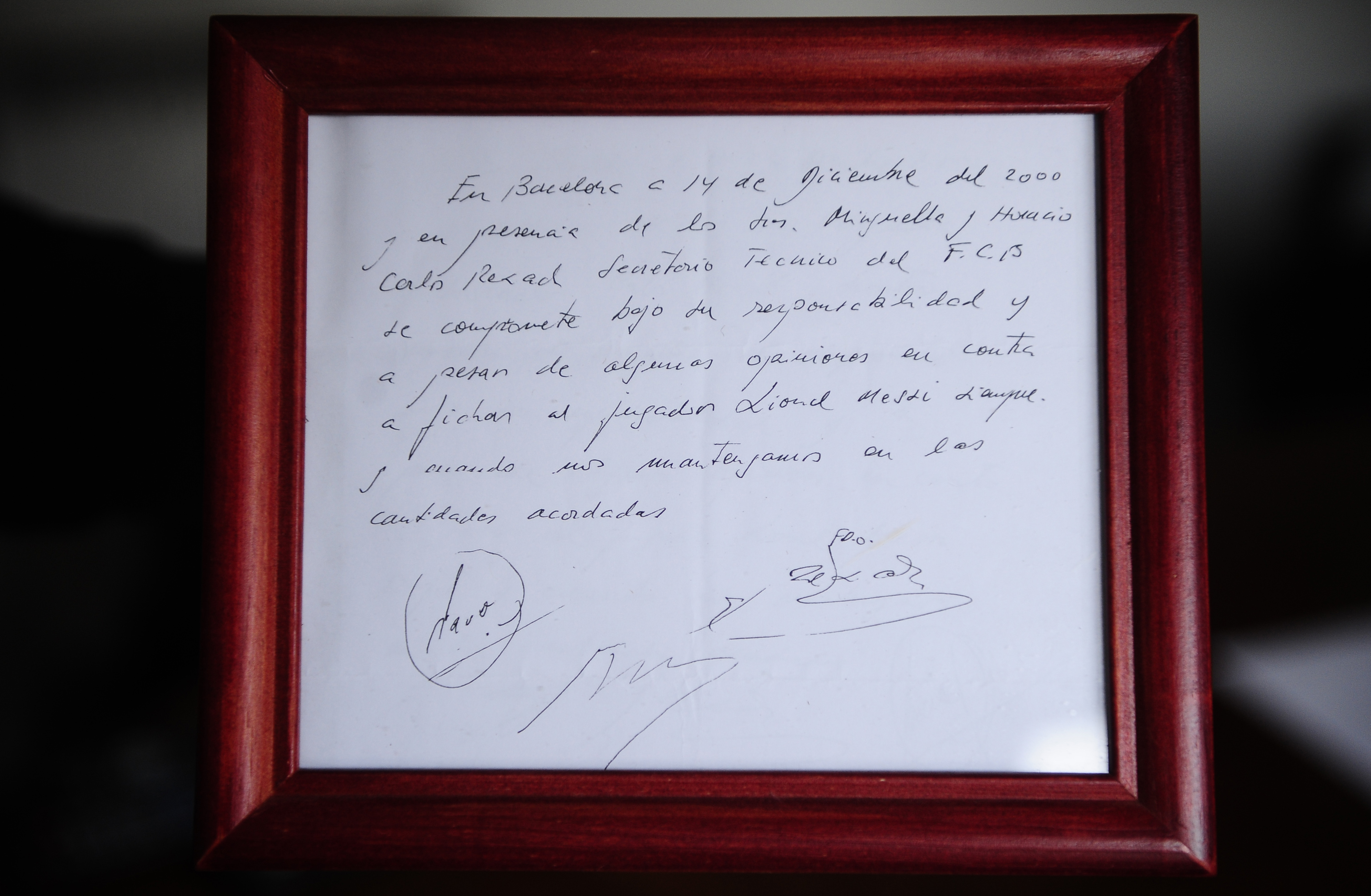 FILE - A framed copy of the napkin linking the 13-year-old Lionel Messi to FC Barcelona is seen in Barcelona, Spain on Jan. 5, 2012. British auction house Bonhams says the famous napkin that linked a young Lionel Messi to Barcelona has sold for $965,000. An agreement in principle to sign then 13-year-old Messi was written on the napkin almost 25 years ago at a Barcelona tennis club. (AP Photo/Manu Fernandez, File)
