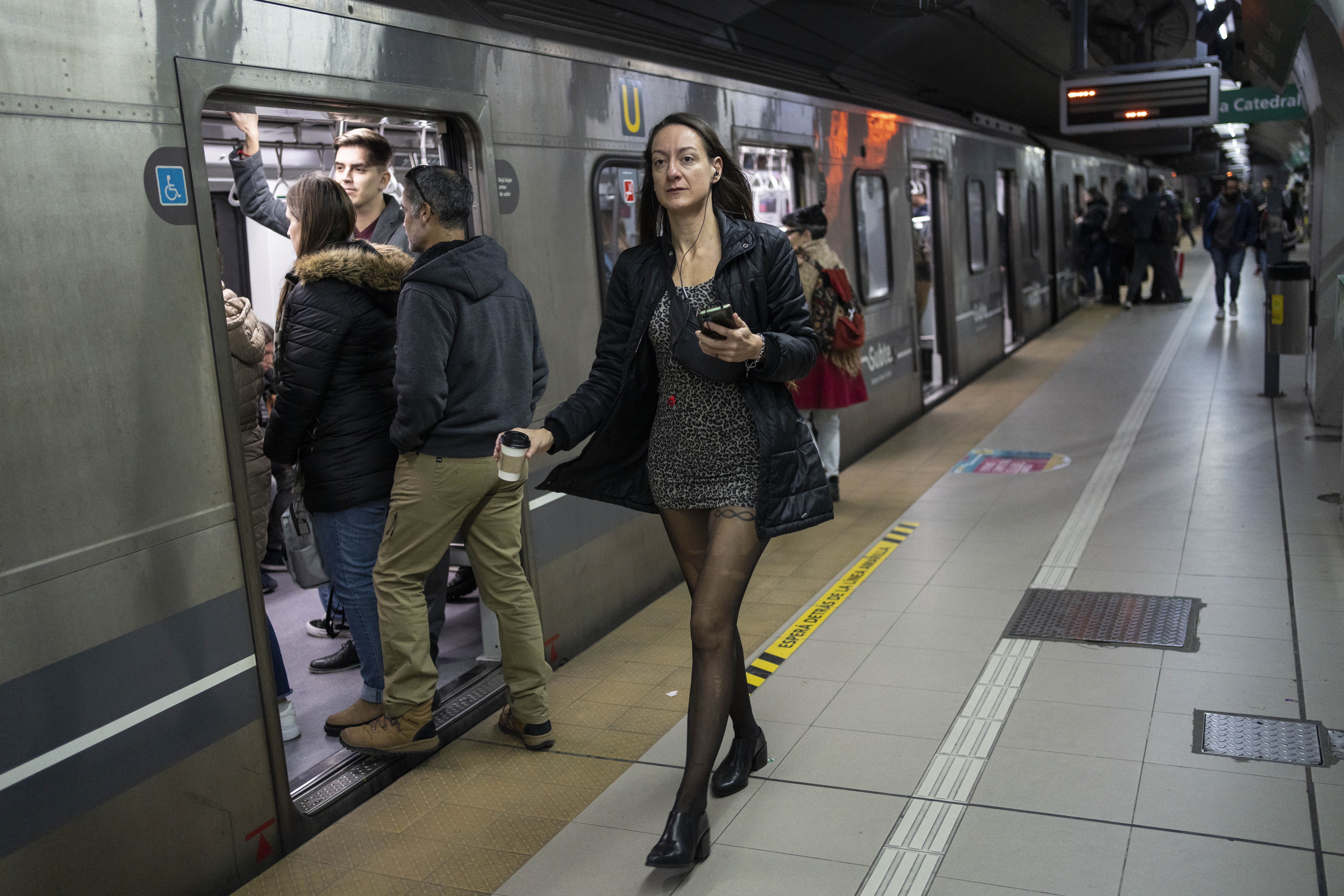 A commuter walks past at a subway station platform, in Buenos Aires, Argentina, Friday, May 17, 2024. Argentine commuters in Buenos Aires on Friday were hit by an abrupt 360% increase in subway fares, as part of President Javier Milei's budget austerity campaign. (AP Photo/Rodrigo Abd)