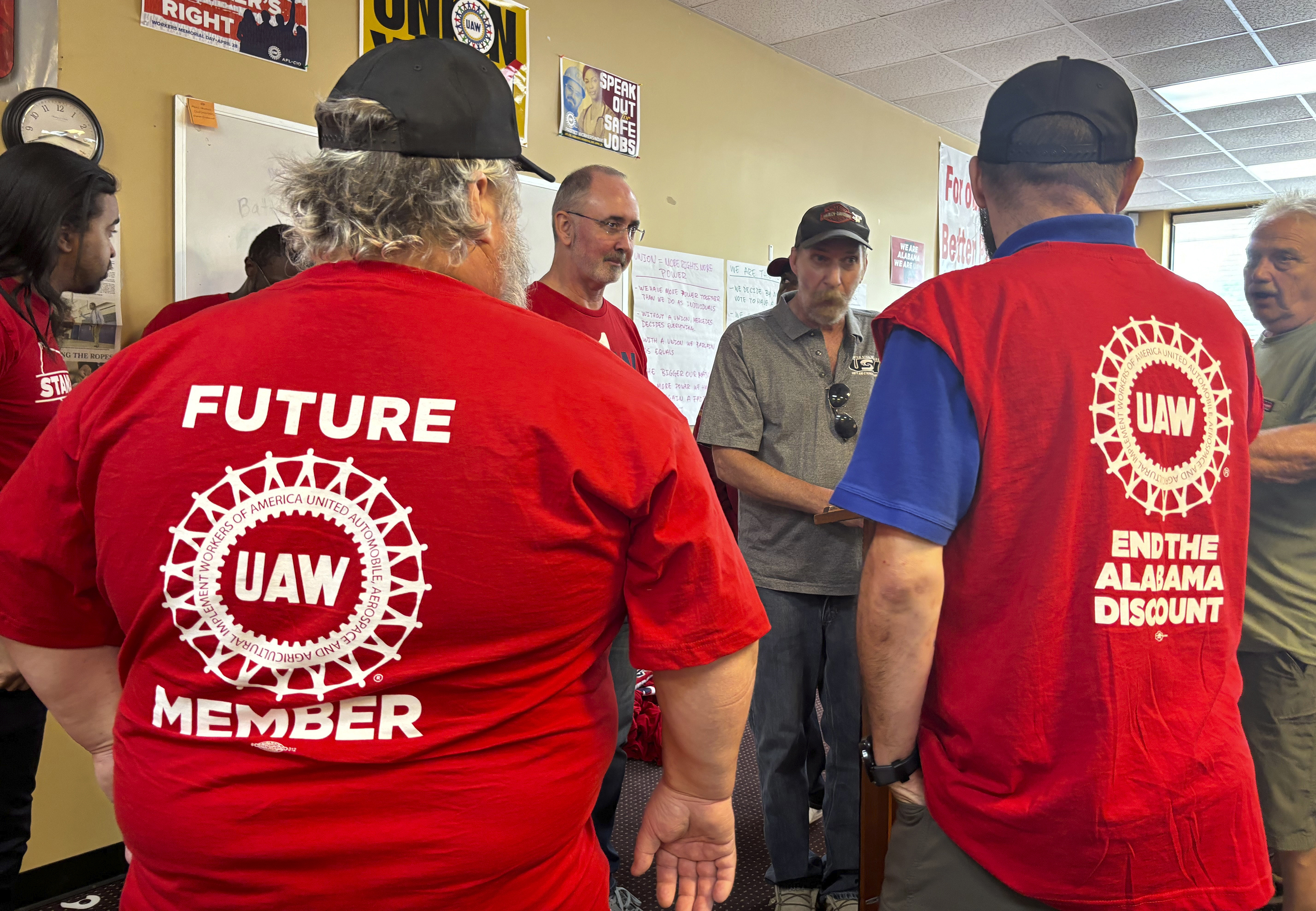 UAW President Shawn Fain, center, speaks with Mercedes workers in Tuscaloosa, Alabama on May 17, 2024 after workers at two Alabama Mercedes-Benz factories voted overwhelmingly against joining the United Auto Workers union. (AP Photo/Kim Chandler)