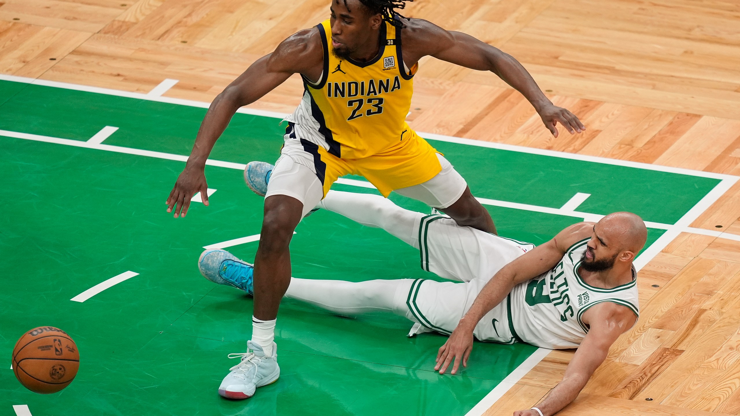 Indiana Pacers forward Aaron Nesmith (23) and Boston Celtics guard Derrick White (9) scramble for a loose ball during the fourth quarter of Game 1 of the NBA Eastern Conference basketball finals, Tuesday, May 21, 2024, in Boston. (AP Photo/Michael Dwyer)