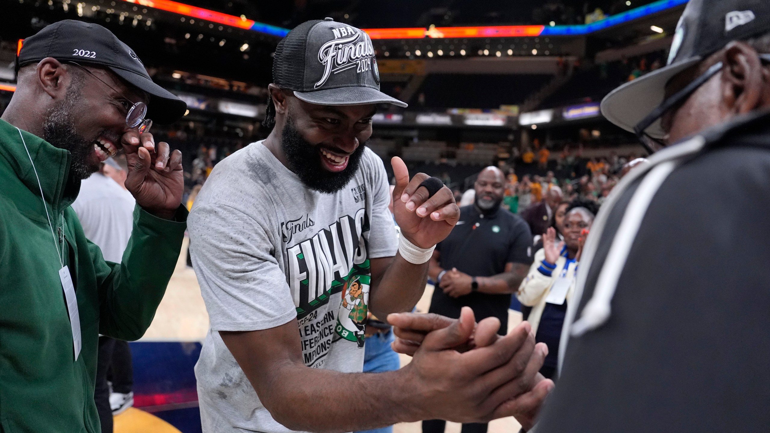 Boston Celtics guard Jaylen Brown celebrates with his family after Game 4 of the NBA Eastern Conference basketball finals against the Indiana Pacers, Monday, May 27, 2024, in Indianapolis. The Celtics won 105-102.(AP Photo/Michael Conroy)