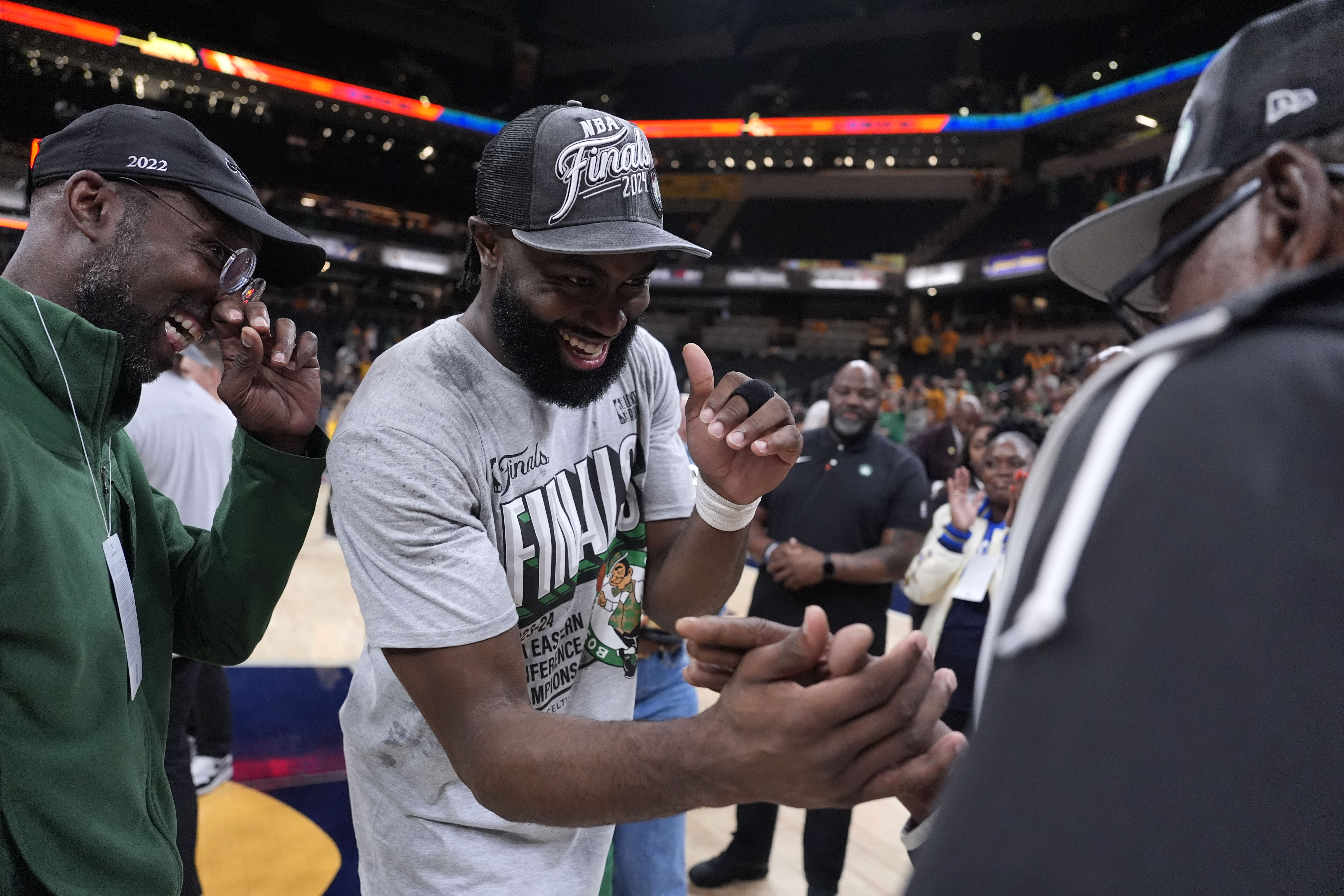 Boston Celtics guard Jaylen Brown celebrates with his family after Game 4 of the NBA Eastern Conference basketball finals against the Indiana Pacers, Monday, May 27, 2024, in Indianapolis. The Celtics won 105-102.(AP Photo/Michael Conroy)