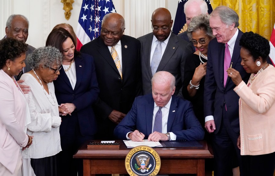 FILE - President Joe Biden signs the Juneteenth National Independence Day Act, in the East Room of the White House, Thursday, June 17, 2021, in Washington. From left, Rep. Barbara Lee, D-Calif, Rep. Danny Davis, D-Ill., Opal Lee, Sen. Tina Smith, D-Minn., obscured, Vice President Kamala Harris, House Majority Whip James Clyburn of S.C., Sen. Raphael Warnock, D-Ga., Sen. John Cornyn, R-Texas, Rep. Joyce Beatty, D-Ohio, Sen. Ed Markey, D-Mass., and Rep. Sheila Jackson Lee, D-Texas. (AP Photo/Evan Vucci, File)