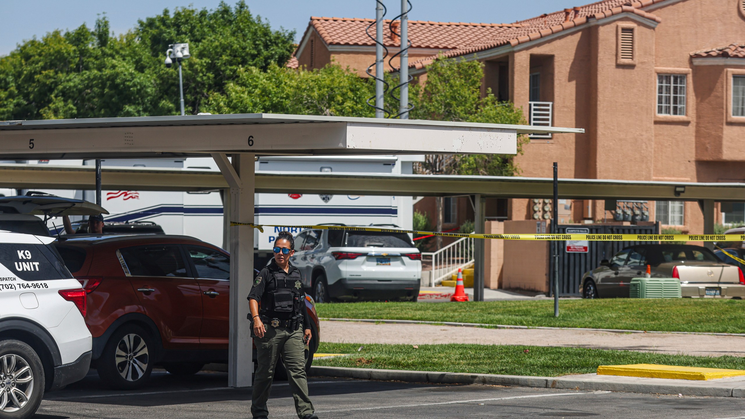 North Las Vegas Police investigate the scene of Monday night's shooting at an apartment complex in North Las Vegas, Tuesday, June 25, 2024. Authorities have arrested a man suspected in shootings Monday night at apartments outside of Las Vegas that left five people dead and a 13-year-old girl critically wounded. (Rachel Aston/Las Vegas Review-Journal via AP)