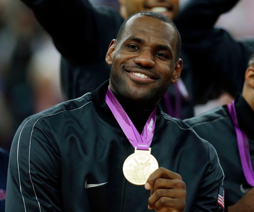 FILE - United States' LeBron James celebrates after winning the gold medal at the men's basketball game against Spain at the 2012 Summer Olympics, in London, Aug. 12, 2012. The NBA's all-time scoring leader seeks his third Olympic gold medal (2008, 2012) and returns to the Games for the first time in 12 years. At 39, James presumably is playing in his final Olympics. (AP Photo/Charles Krupa, File)