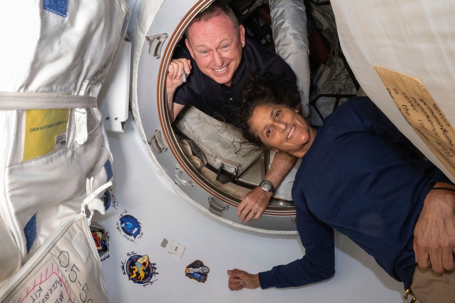 In this photo provided by NASA, Boeing Crew Flight Test astronauts Butch Wilmore, left, and Suni Williams pose for a portrait inside the vestibule between the forward port on the International Space Station's Harmony module and Boeing's Starliner spacecraft on June 13, 2024. (NASA via AP)