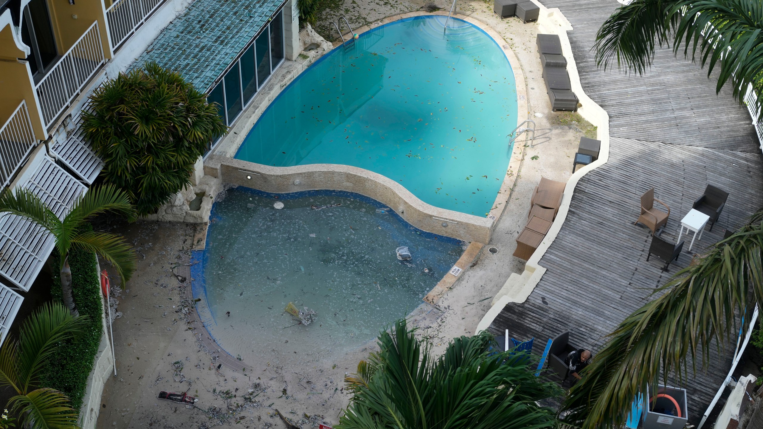 A hotel swimming pool remains closed the day after wind from Hurricane Beryl filled it with sand and debris in Bridgetown, Barbados, Tuesday, July 2, 2024. (AP Photo/Ricardo Mazalan)
