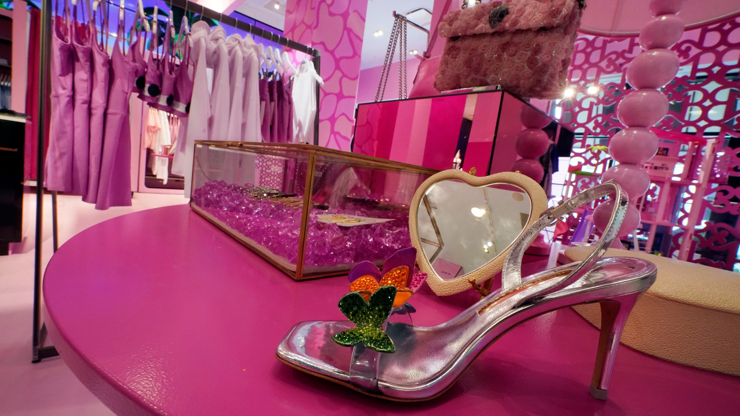FILE - Barbie-themed merchandise is displayed in a special section at Bloomingdale's, in New York, Thursday, July 20, 2023. According to the fashion company LYST, the "Barbiecore" trend began after pictures of a pink-clad Margot Robbie surfaced online in June 2022, a year before the actor's "Barbie" movie came out and toy maker Mattel launched its own marketing blitz to promote the color. (AP Photo/Richard Drew, File)