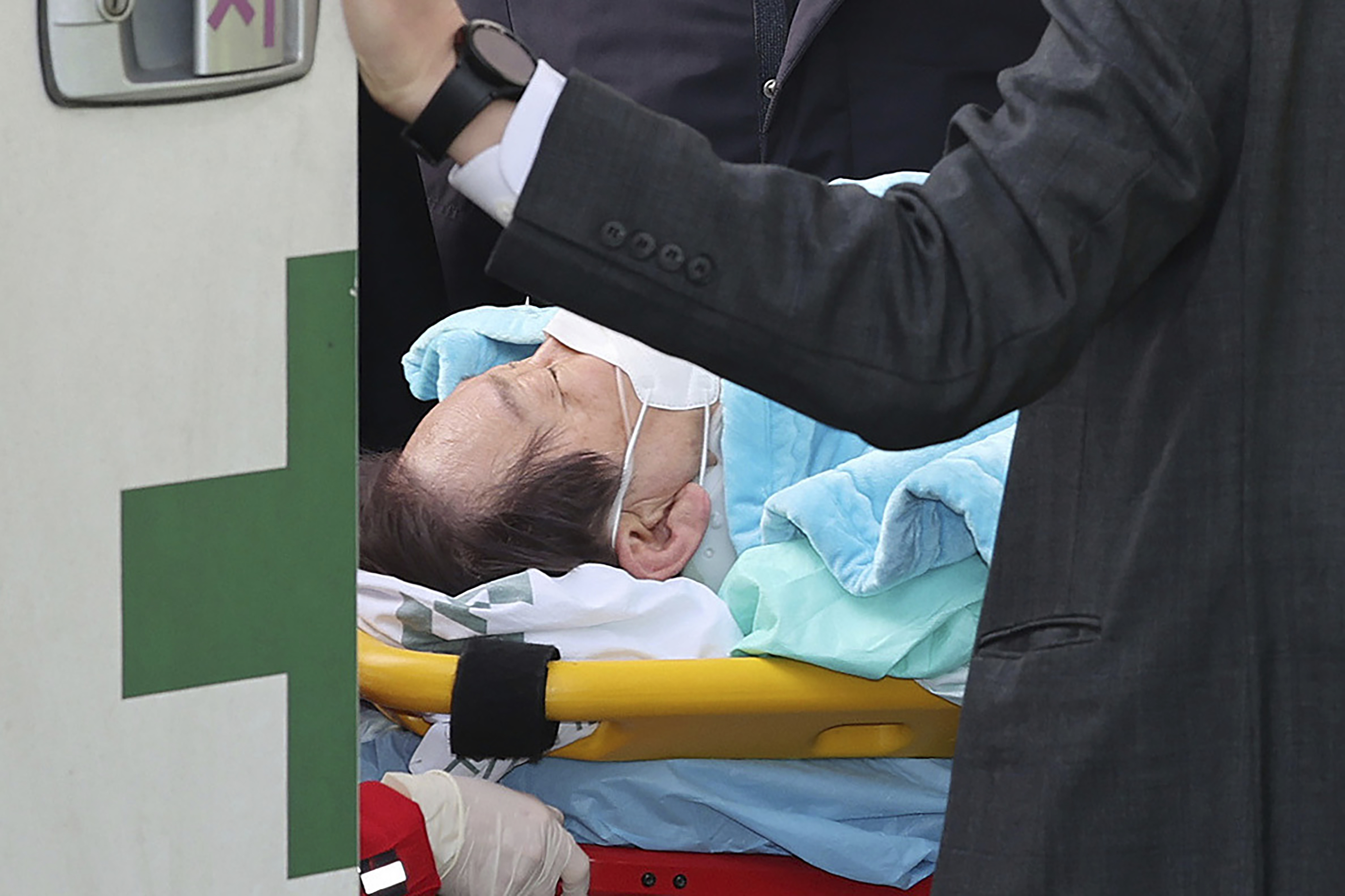 FILE - Then South Korea's main opposition Democratic Party leader Lee Jae-myung on a stretcher arrives at a heliport in Seoul, South Korea, on Jan. 2, 2024. A man who stabbed Lee in the neck earlier this year was sentenced to 15 years in prison on Friday, July 5, 2024, court officials said. (Im Hwa-young/Yonhap via AP, File)