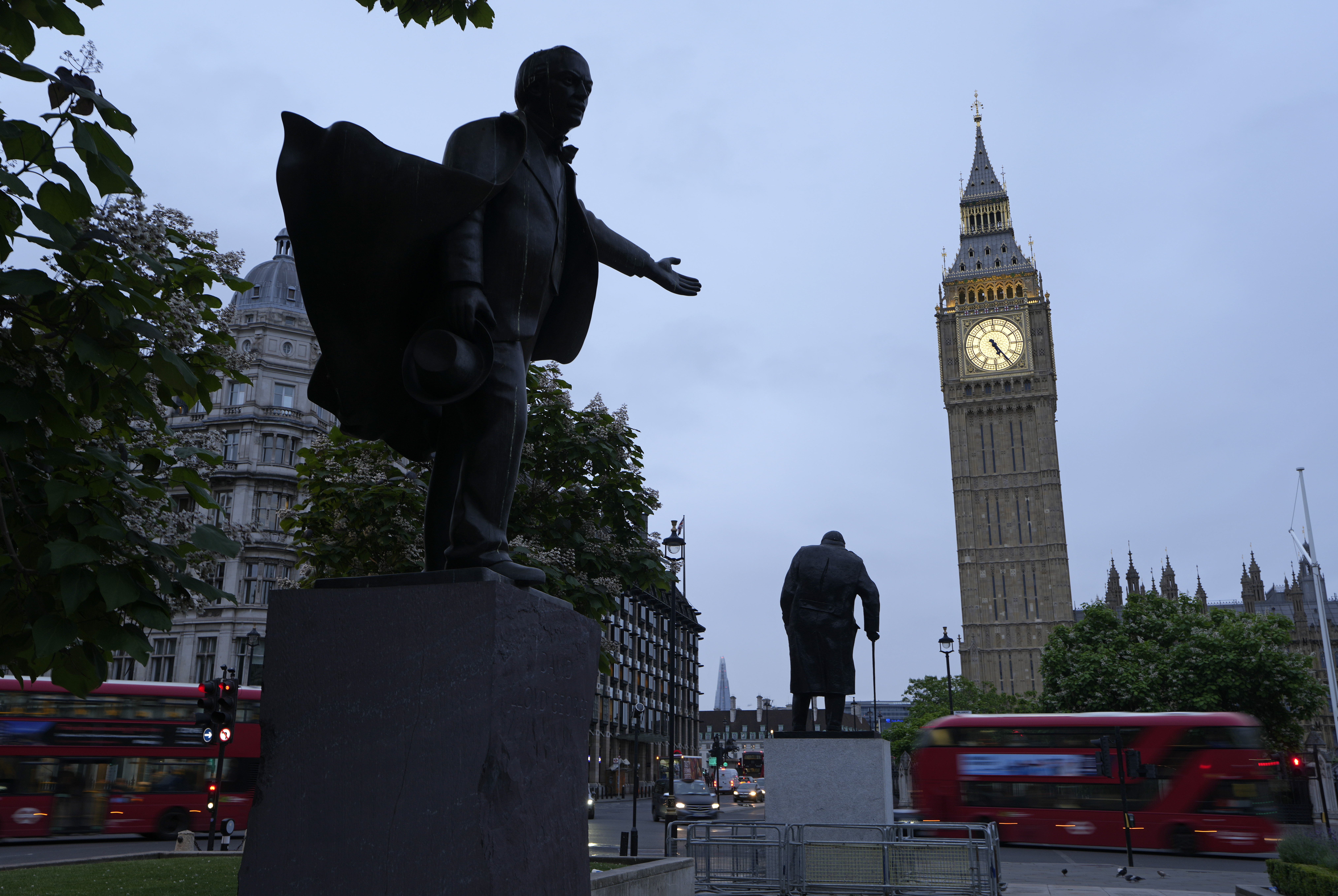 The statues of former British Prime Minister's David Lloyd George, left, and Winston Churchill stand in Parliament Square in Westminster across from the Houses of Parliament in London, Friday, July 5, 2024. Britain's Labour Party swept to power Friday after more than a decade in opposition, as a jaded electorate handed the party a landslide victory — but also a mammoth task of reinvigorating a stagnant economy and dispirited nation. (AP Photo/Vadim Ghirda)