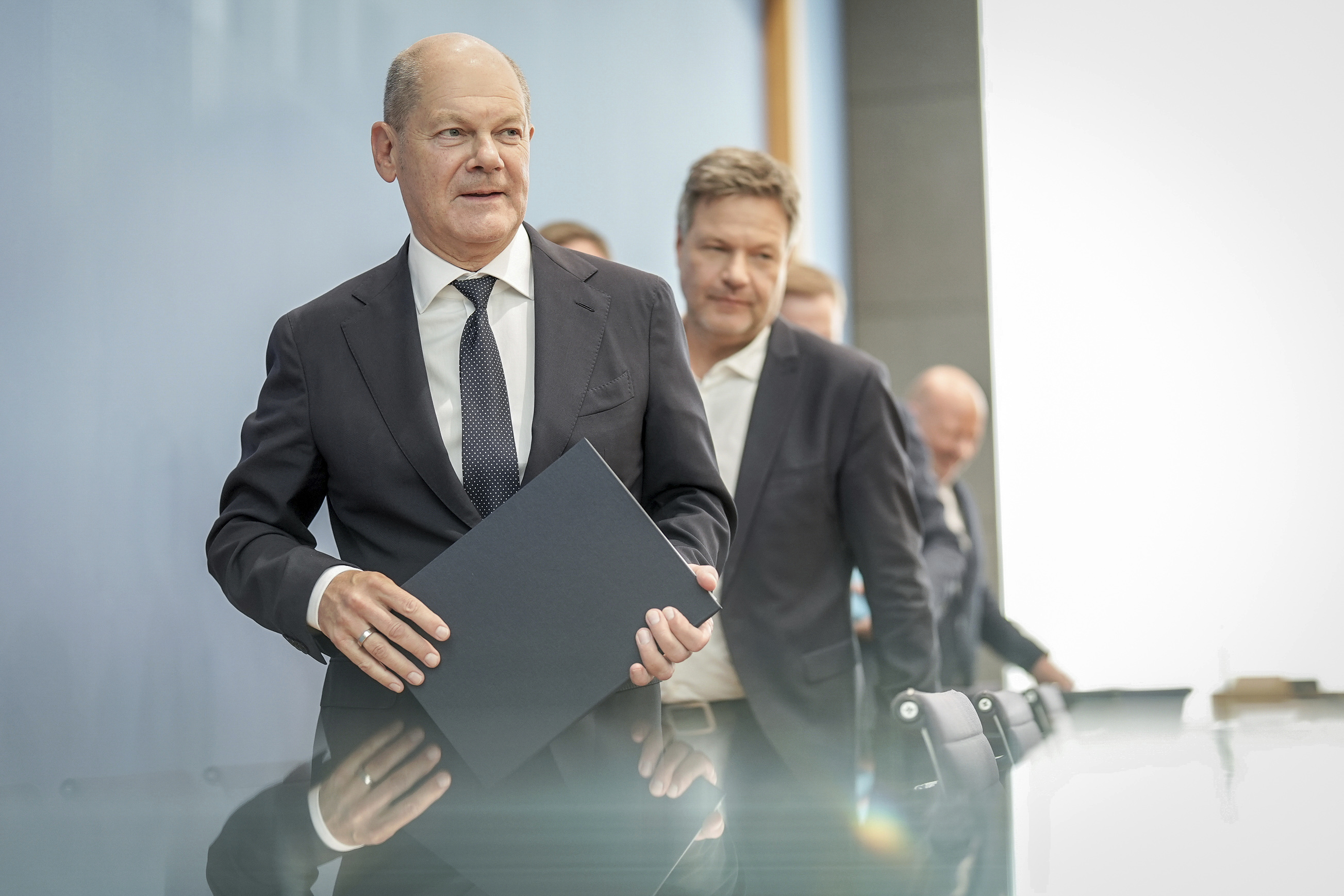 German Chancellor Olaf Scholz, left, followed by German Minister for Economic Affairs and Climate Protection Robert Habeck, leave following a press conference on the 2025 budget, in Berlin, Friday, July 5, 2024. The coalition parties have agreed on a draft budget. (Kay Nietfeld/dpa via AP)