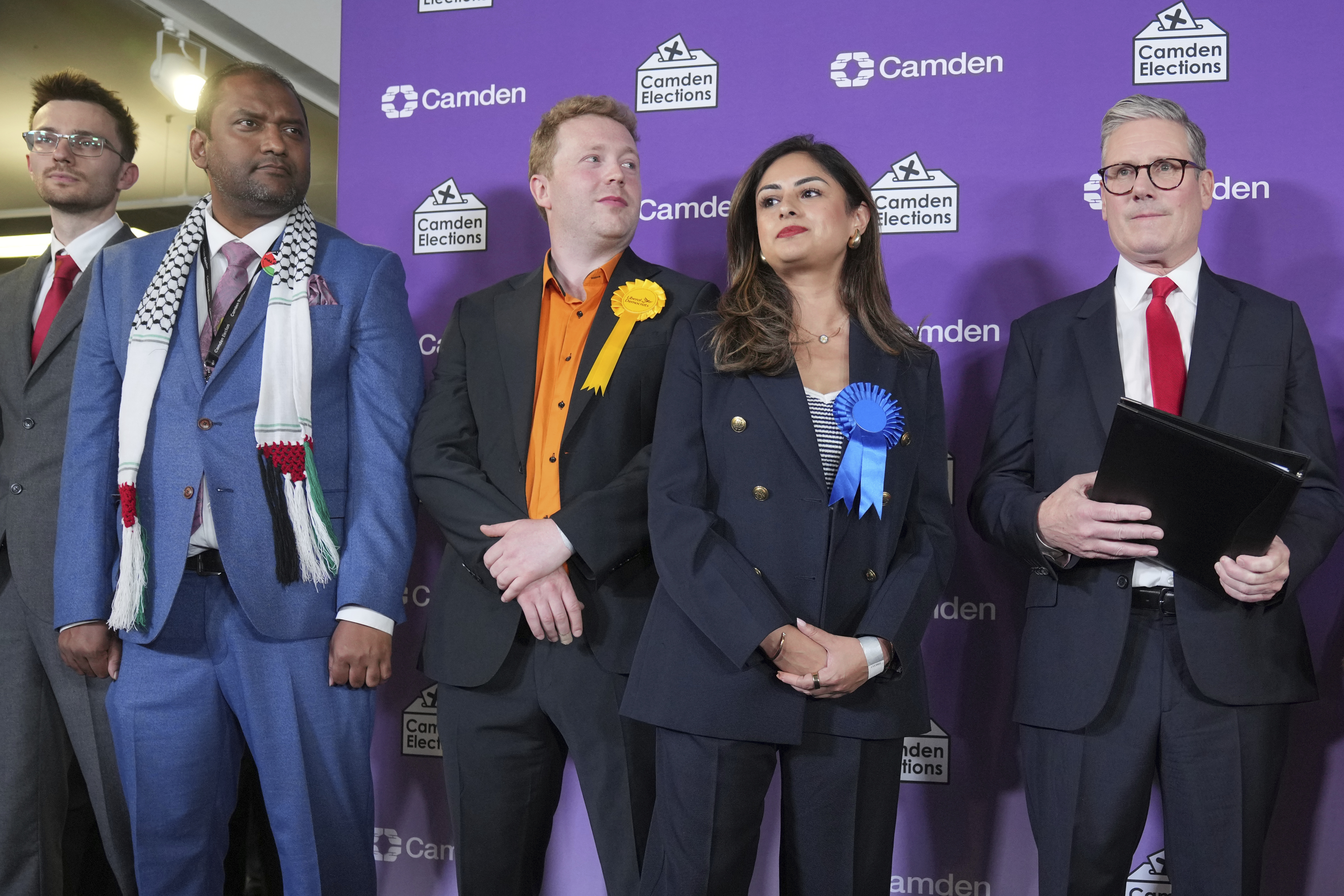 Britain's Labour Party leader Keir Starmer, right, lines up on stage with some of the other candidates as they await the result of the Holborn and St Pancras constituency, in London, Friday, July 5, 2024. Britain's Labour Party appears to be headed for a huge majority in the 2024 UK election, an exit poll suggested. The poll released moments after voting closed indicated that Labour leader Keir Starmer will be the country's next prime minister. (AP Photo/Kin Cheung)