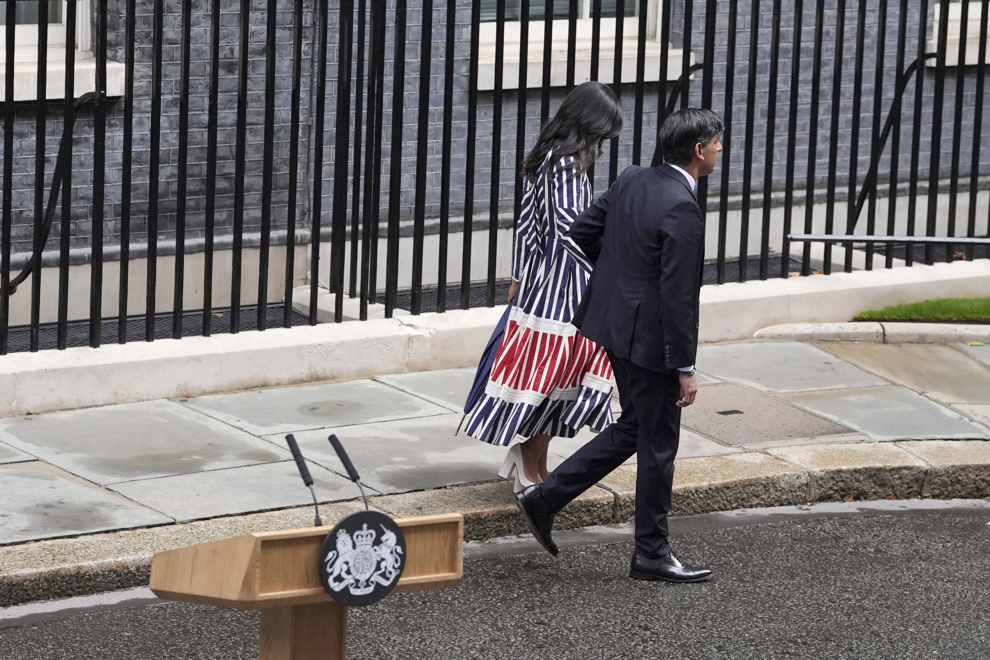 Britain's outgoing Conservative Party Prime Minister Rishi Sunak and his wife Akshata Murty walk from 10 Downing Street to a waiting car before going to see King Charles III to tender his resignation in London, Friday, July 5, 2024. Sunak and his Conservative Party lost the general election held July 4, to the Labour Party, whose leader Keir Starmer is set become Prime Minister later Friday. (Gareth Fuller/PA via AP)