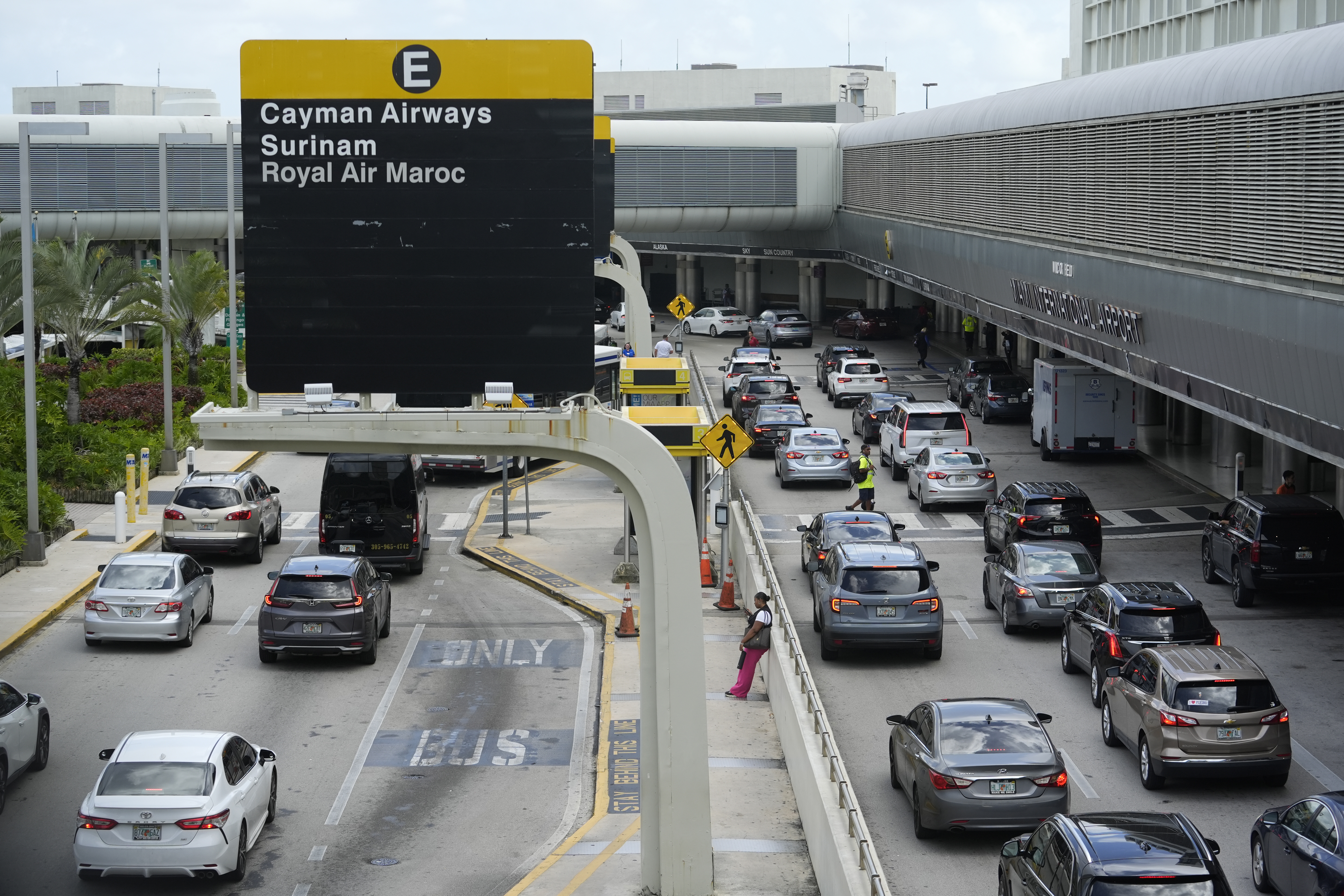 Vehicles drive along the departures area at Miami International Airport, Wednesday, July 3, 2024, in Miami. (AP Photo/Lynne Sladky)