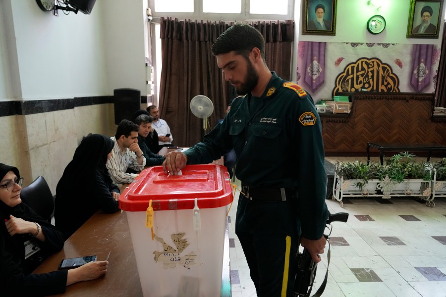 An Iranian policeman casts his vote for the presidential runoff election at a polling station in Tehran, Iran, Friday, July 5, 2024. Iranians began voting Friday in a runoff election to replace the late President Ebrahim Raisi, killed in a helicopter crash last month, as public apathy has become pervasive in the Islamic Republic after years of economic woes, mass protests and tensions in the Middle East. (AP Photo/Vahid Salemi)