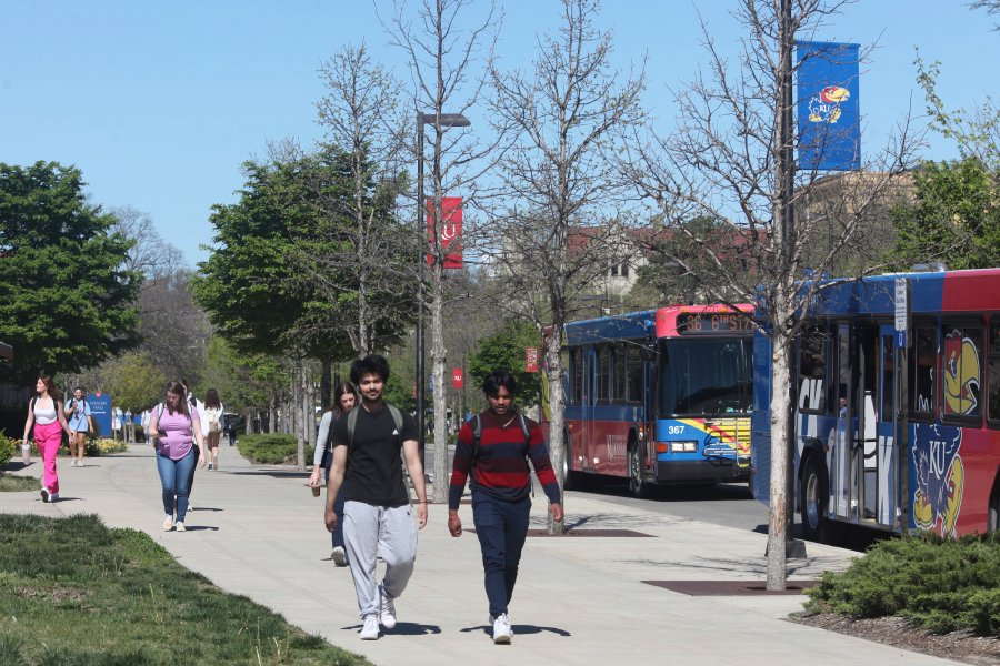 FILE - Students walk down Jayhawk Boulevard, the main street through the main University of Kansas campus, Friday, April 12, 2024, in Lawrence, Kan. Americans are increasingly skeptical about the value and cost of college, with most saying they feel the U.S. higher education system is headed in the “wrong direction,” according to a new poll. (AP Photo/John Hanna, File)