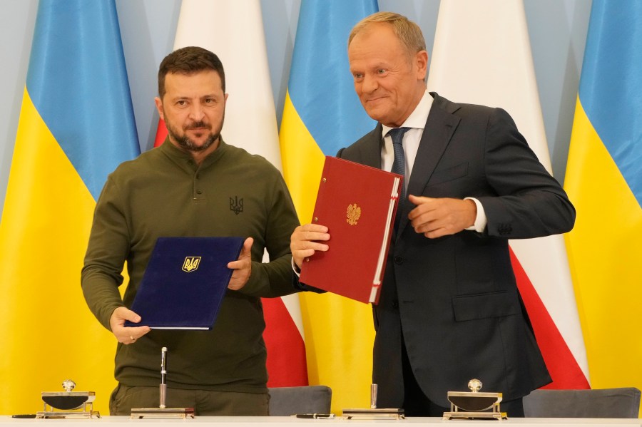 Poland's Prime Minister Donald Tusk, right, and Ukraine's President Volodymyr Zelenskyy after signing an agreement of cooperation and defense, in Warsaw, Poland, on Monday, July 8, 2024. (AP Photo/Czarek Sokolowski)