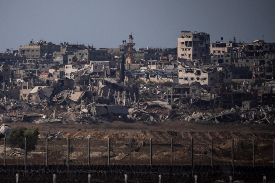 Destroyed buildings stand in the Gaza Strip, as seen from southern Israel, Monday, July 8, 2024. Israeli forces advanced deeper into the Gaza Strip's largest city in pursuit of militants who had regrouped there, sending thousands of Palestinians fleeing on Monday from an area ravaged in the early weeks of the nine-month-long war. (AP Photo/Leo Correa)