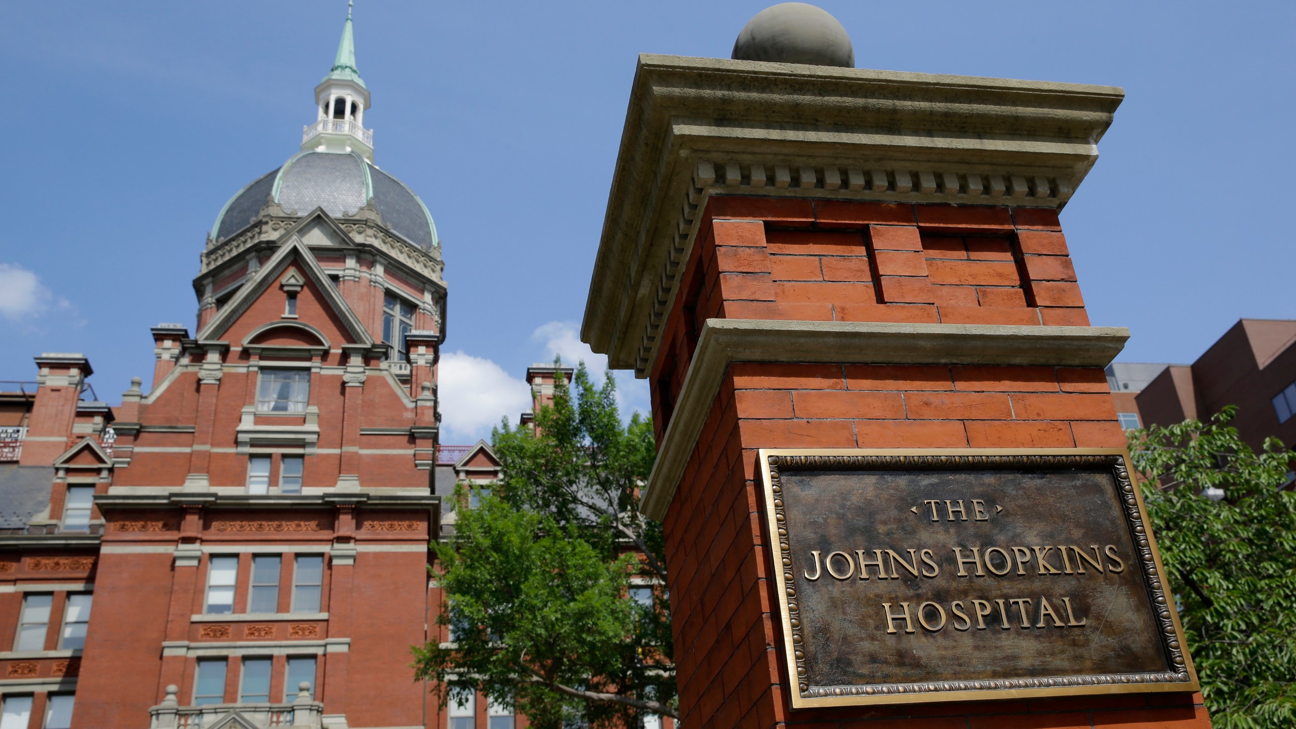 A sign stands in front of part of the Johns Hopkins Hospital complex, July 8, 2014, in Baltimore. Most medical students at Johns Hopkins University will no longer pay tuition thanks to a $1 billion gift from Bloomberg Philanthropies. Starting in the fall, the gift announced Monday, July 8, 2024 will cover full tuition for medical students from families earning less than $300,000. (AP Photo/Patrick Semansky, file)