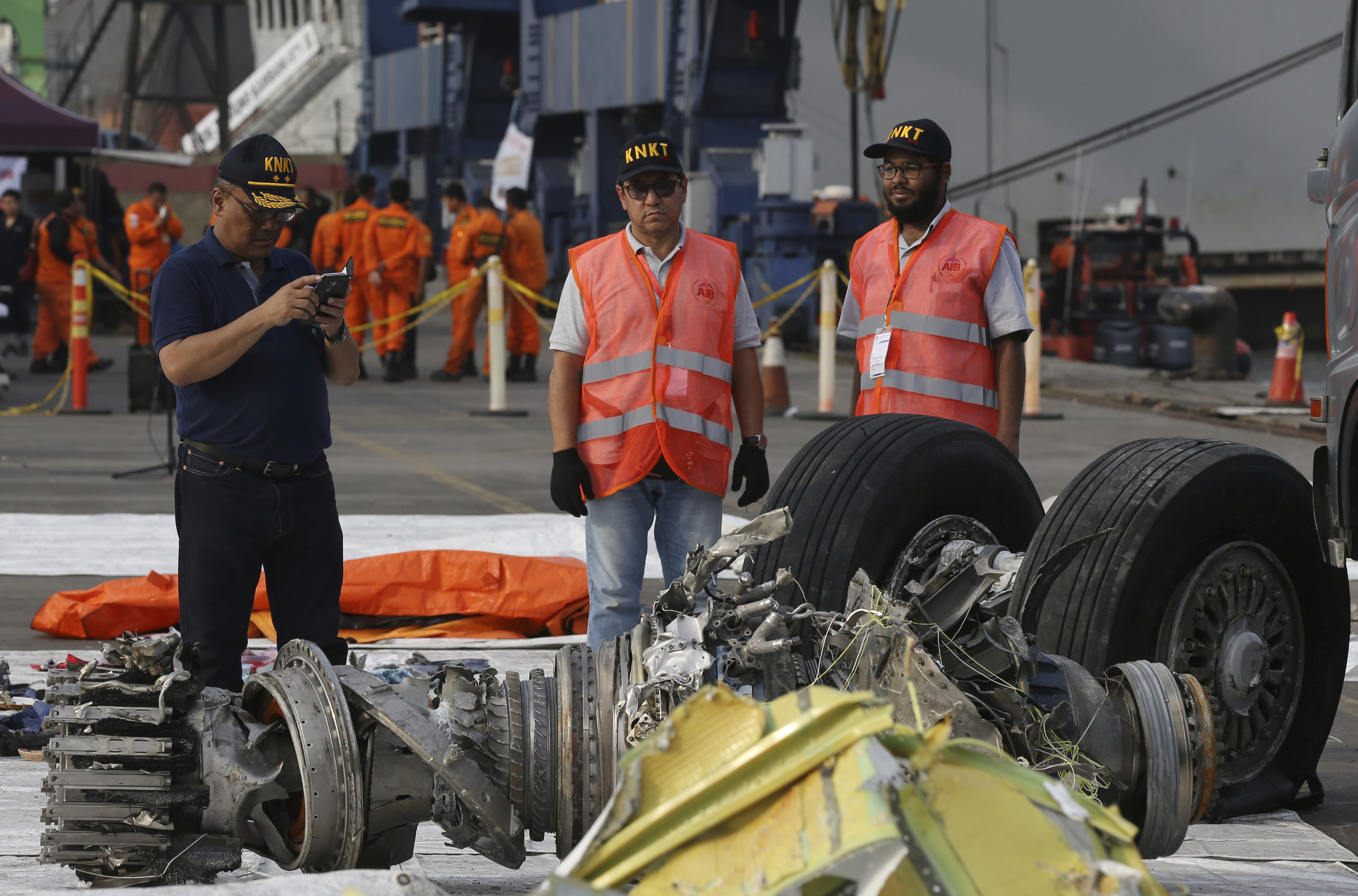 FILE - Officials inspect an engine recovered from the crashed Lion Air jet in Jakarta, Indonesia, Nov. 4, 2018. The brand new Boeing 737 MAX 8 jet plunged into the Java Sea just minutes after takeoff from Jakarta early on Oct. 29, killing all of its passengers on board. On Sunday, July 7, 2024, the Justice Department said Boeing has agreed to plead guilty to a criminal fraud charge stemming from two deadly crashes of 737 Max jetliners. (AP Photo/Achmad Ibrahim, File)