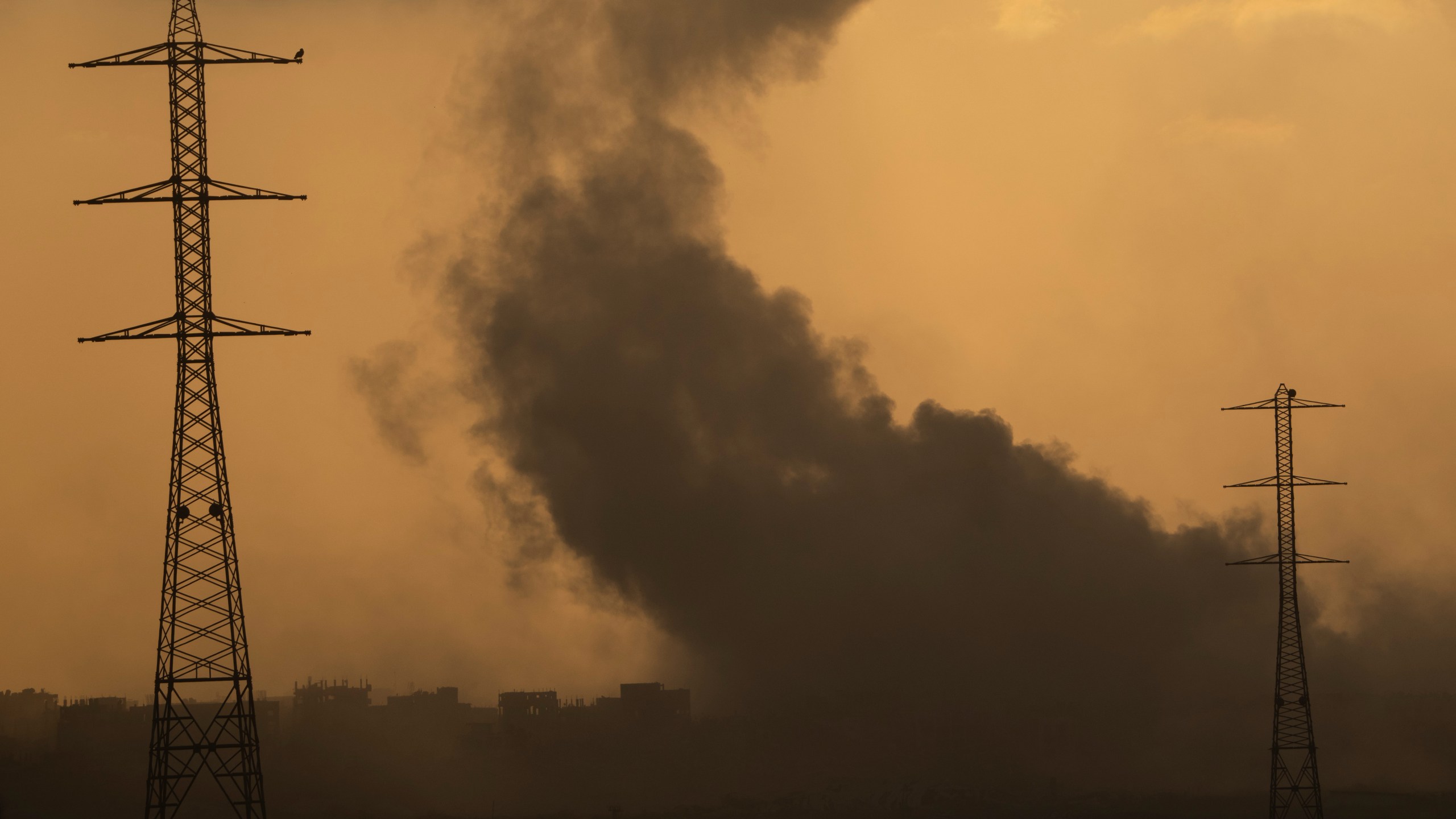 Smoke rises to the sky after an explosion in the Gaza Strip as seen from southern Israel, Monday, July 8, 2024. Israeli forces advanced deeper into the Gaza Strip's largest city in pursuit of militants who had regrouped there, sending thousands of Palestinians fleeing on Monday from an area ravaged in the early weeks of the nine-month-long war. (AP Photo/Leo Correa)