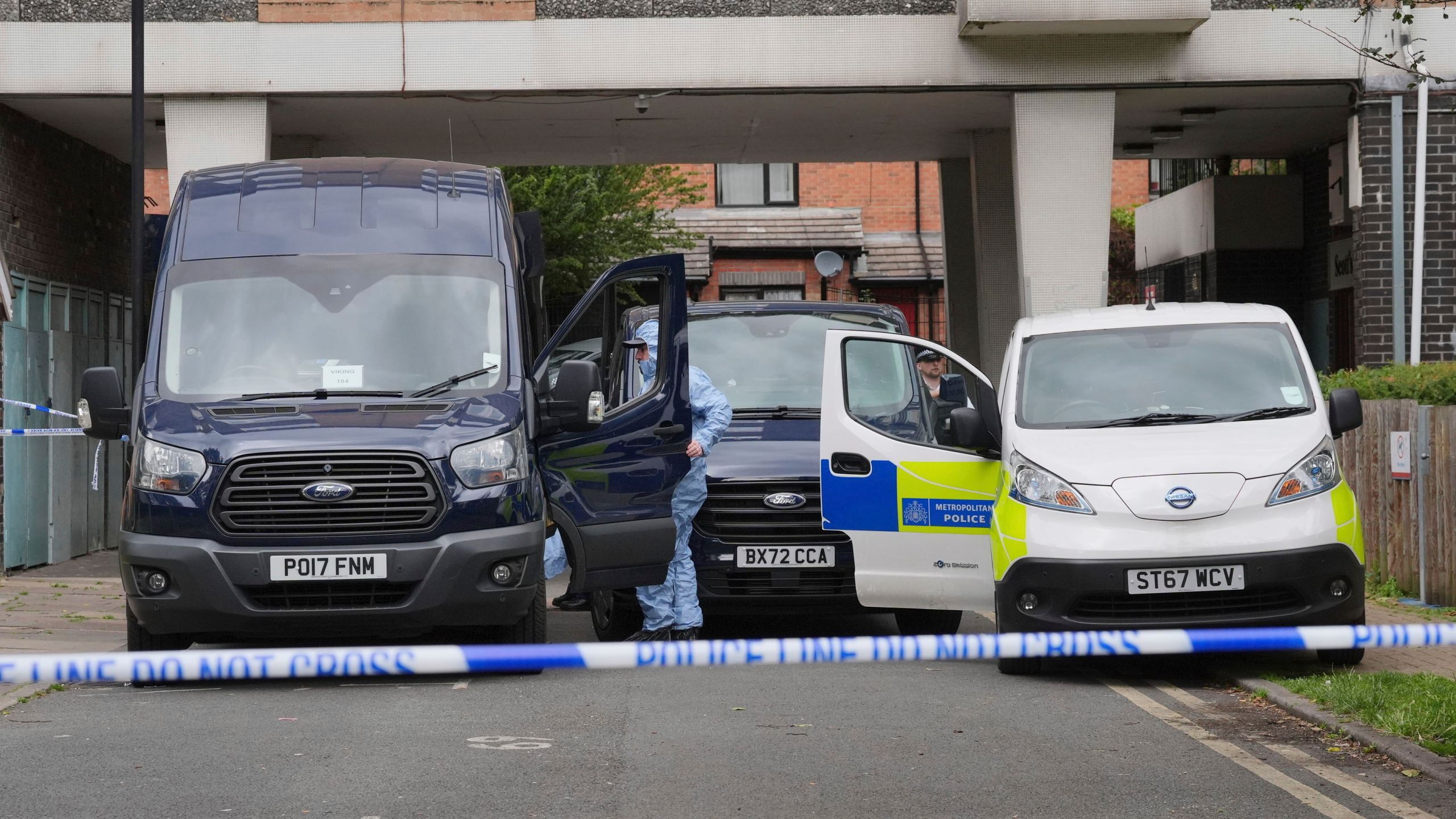 Forensic officers at the scene at an address in Shepherd's Bush, after human remains were found in two suitcases near the Clifton Suspension Bridge in Bristol, Saturday, July 13, 2024, in London. Police said human remains were found at an address in Shepherd's Bush, west London believed to be connected to those found in the suitcases dumped near the Clifton Suspension Bridge in Bristol on Wednesday. (Jonathan Brady/PA via AP)