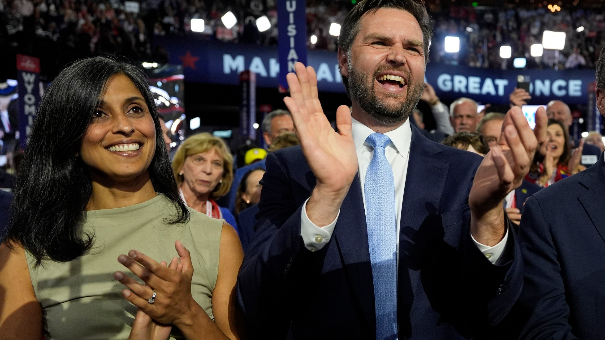 Republican vice presidential candidate Sen. JD Vance, R-Ohio, and his wife Usha Chilukuri Vance arrive on the floor during the first day of the 2024 Republican National Convention at the Fiserv Forum, Monday, July 15, 2024, in Milwaukee. (AP Photo/Carolyn Kaster)