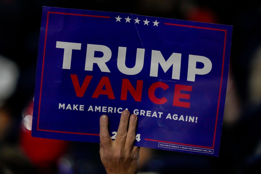 A suppoerter holds a sign during the Republican National Convention Tuesday, July 16, 2024, in Milwaukee. (AP Photo/Charles Rex Arbogast)