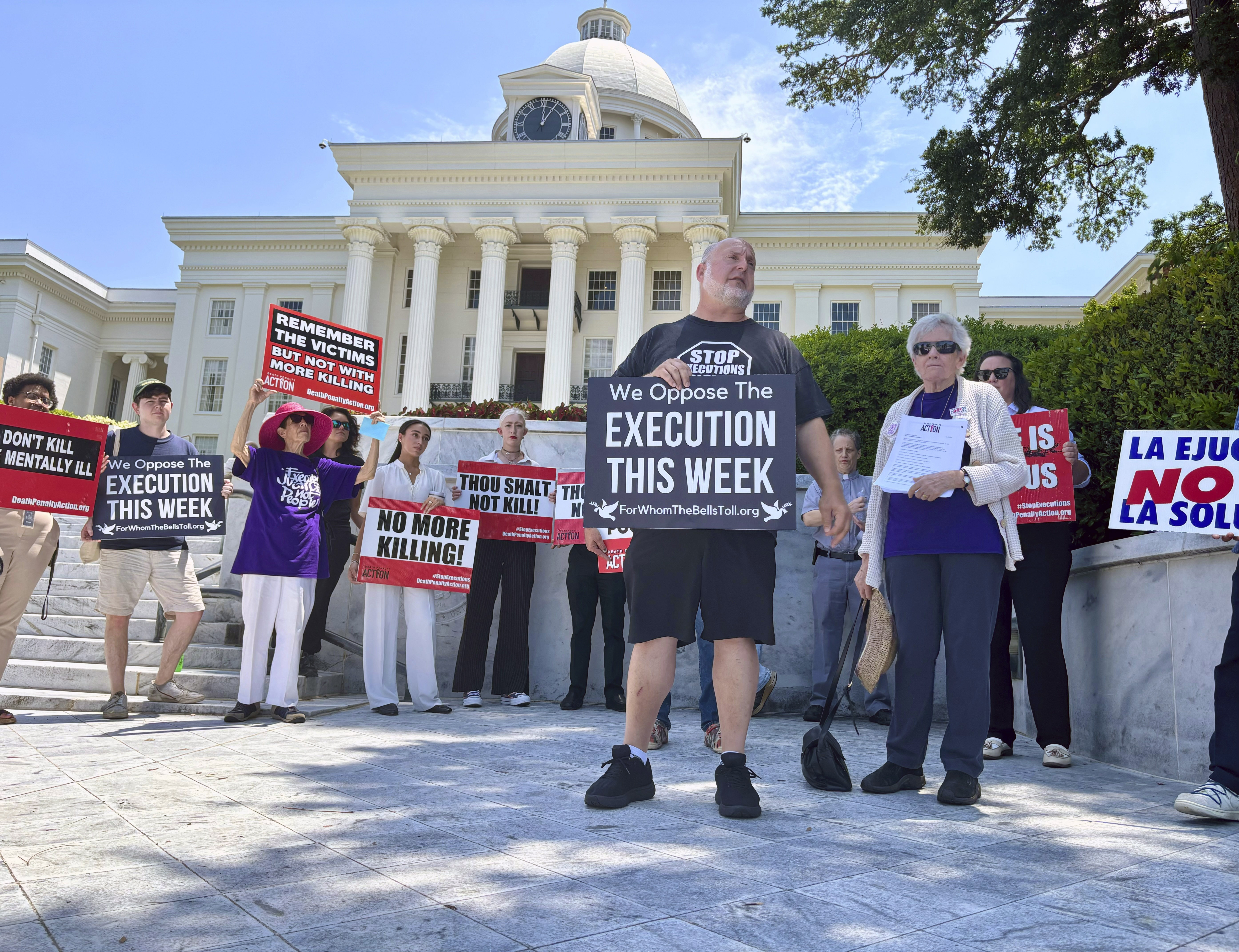 Abraham Bonowitz of Death Penalty Action and Esther Brown of Project Hope to Abolish the Death Penalty in Alabama stand with other death penalty opponents at a Tuesday, July 16, 2024 rally in front of the Alabama Capitol in Montgomery, Ala. (AP Photo/Kim Chandler)