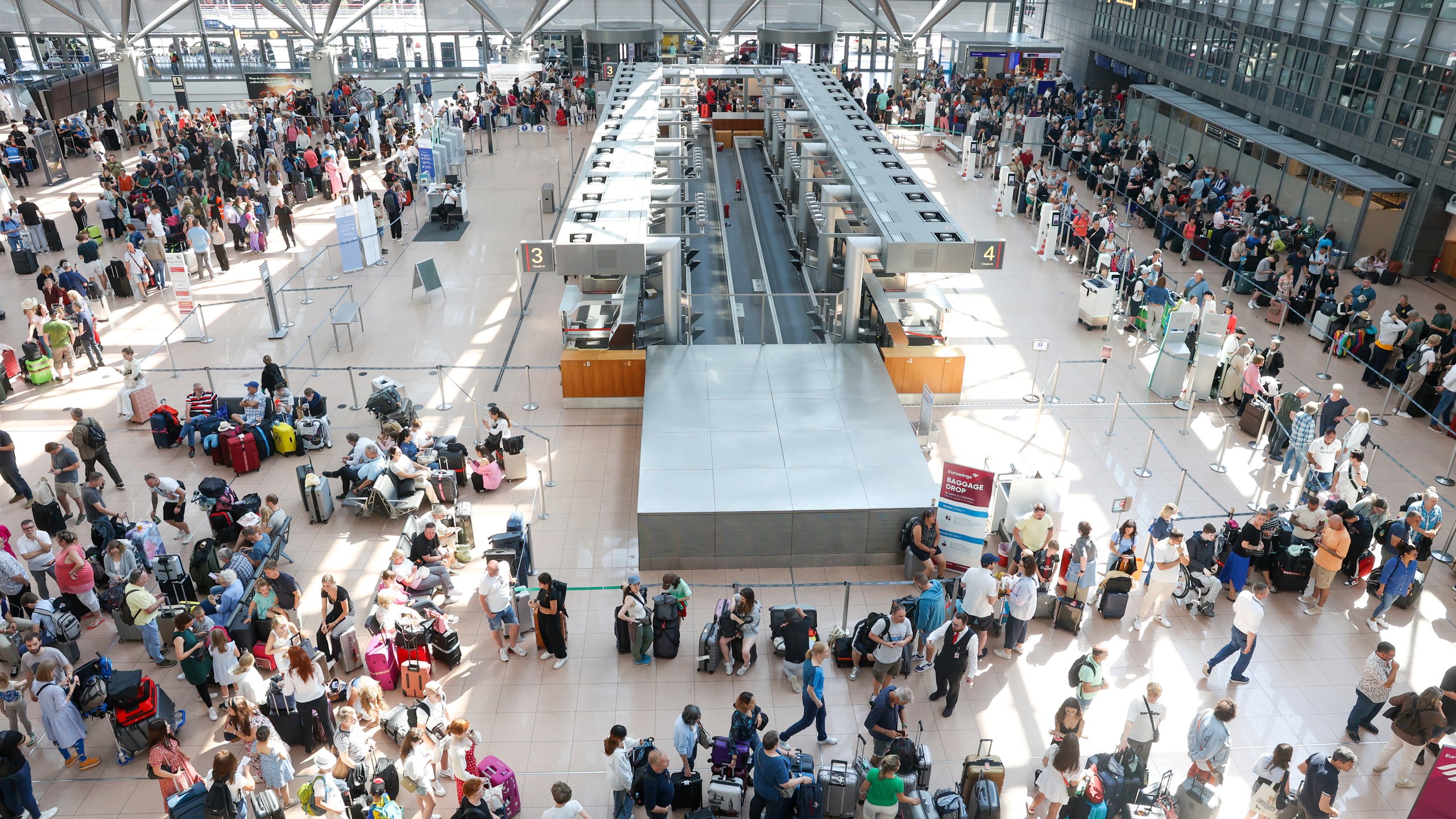 Travelers wait in Terminal 1 for check-in at Hamburg Airport, in Hamburg, Germany, Friday July 19, 2024. A widespread Microsoft outage disrupted flights, banks, media outlets and companies around the world on Friday. (Bodo Marks/dpa via AP)