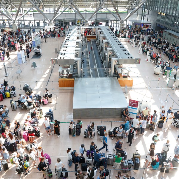 Travelers wait in Terminal 1 for check-in at Hamburg Airport, in Hamburg, Germany, Friday July 19, 2024. A widespread Microsoft outage disrupted flights, banks, media outlets and companies around the world on Friday. (Bodo Marks/dpa via AP)