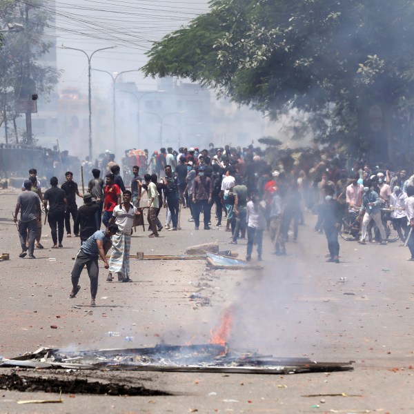 Students clash with riot police during a protest against a quota system for government jobs, in Dhaka, Bangladesh, Thursday, July 18, 2024. (AP Photo/Rajib Dhar)