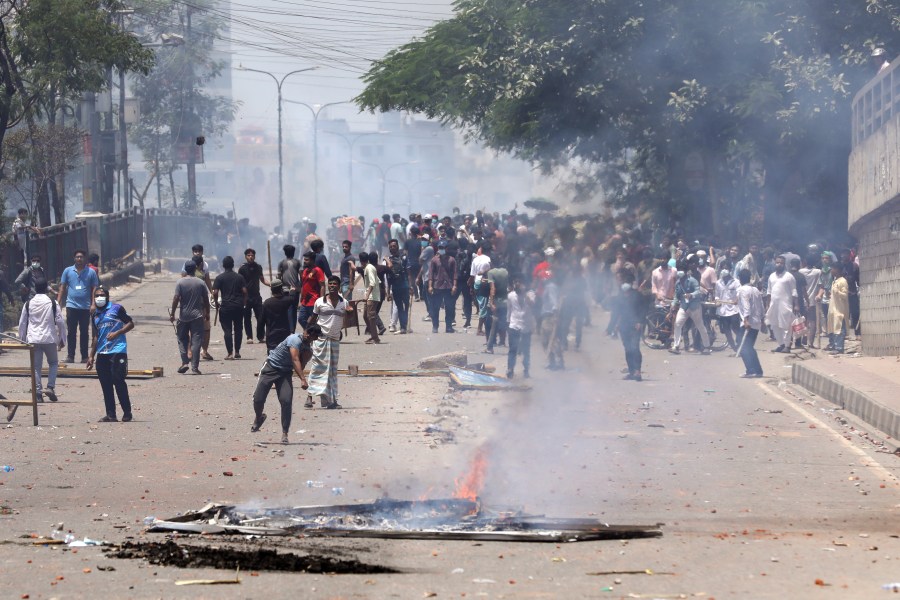 Students clash with riot police during a protest against a quota system for government jobs, in Dhaka, Bangladesh, Thursday, July 18, 2024. (AP Photo/Rajib Dhar)