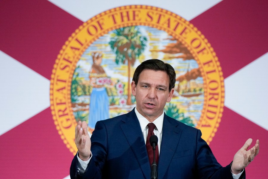 FILE - Florida Gov. Ron DeSantis speaks during a news conference in Miami, on May 9, 2023. The Treasury Department is warning that state laws that restrict banks from considering environmental, social and governance factors could harm efforts to address money laundering and terrorism financing. The Associated Press obtained a copy of a letter sent Thursday to lawmakers. The letter single out a law signed by Florida Gov. Ron DeSantis in May that says it would be an “unsafe and unsound practice” for banks to consider non-financial factors when doing business. (AP Photo/Rebecca Blackwell, File)