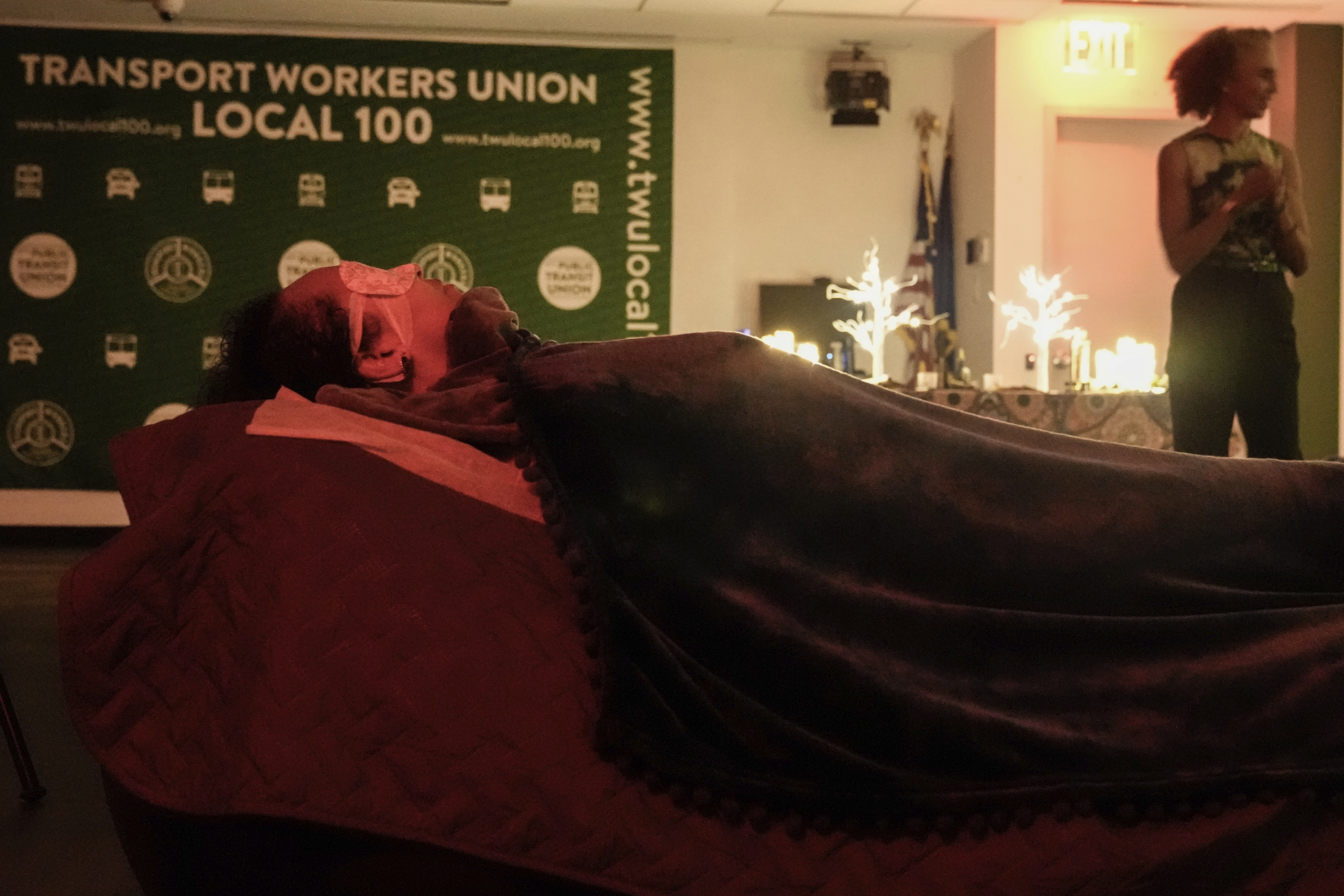 Transit Workers take part in a guided relaxation class Friday, May 17, 2024, in the Brooklyn borough of New York. The class, held at a union hall for New York City transit employees, has emerged as one of several ways in which transportation workers around the country are trying to manage their fear and anxiety over a rise in violent crime on subways and buses. (AP Photo/Frank Franklin II)