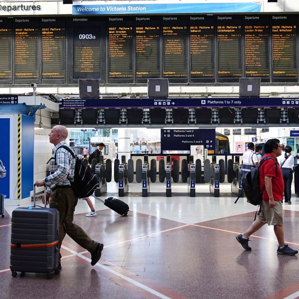 Passengers walk at Victoria train station, in London, amid reports of widespread IT outages affecting airlines, broadcasters and banks, Friday July 19, 2024. (Aaron Chown/PA via AP)